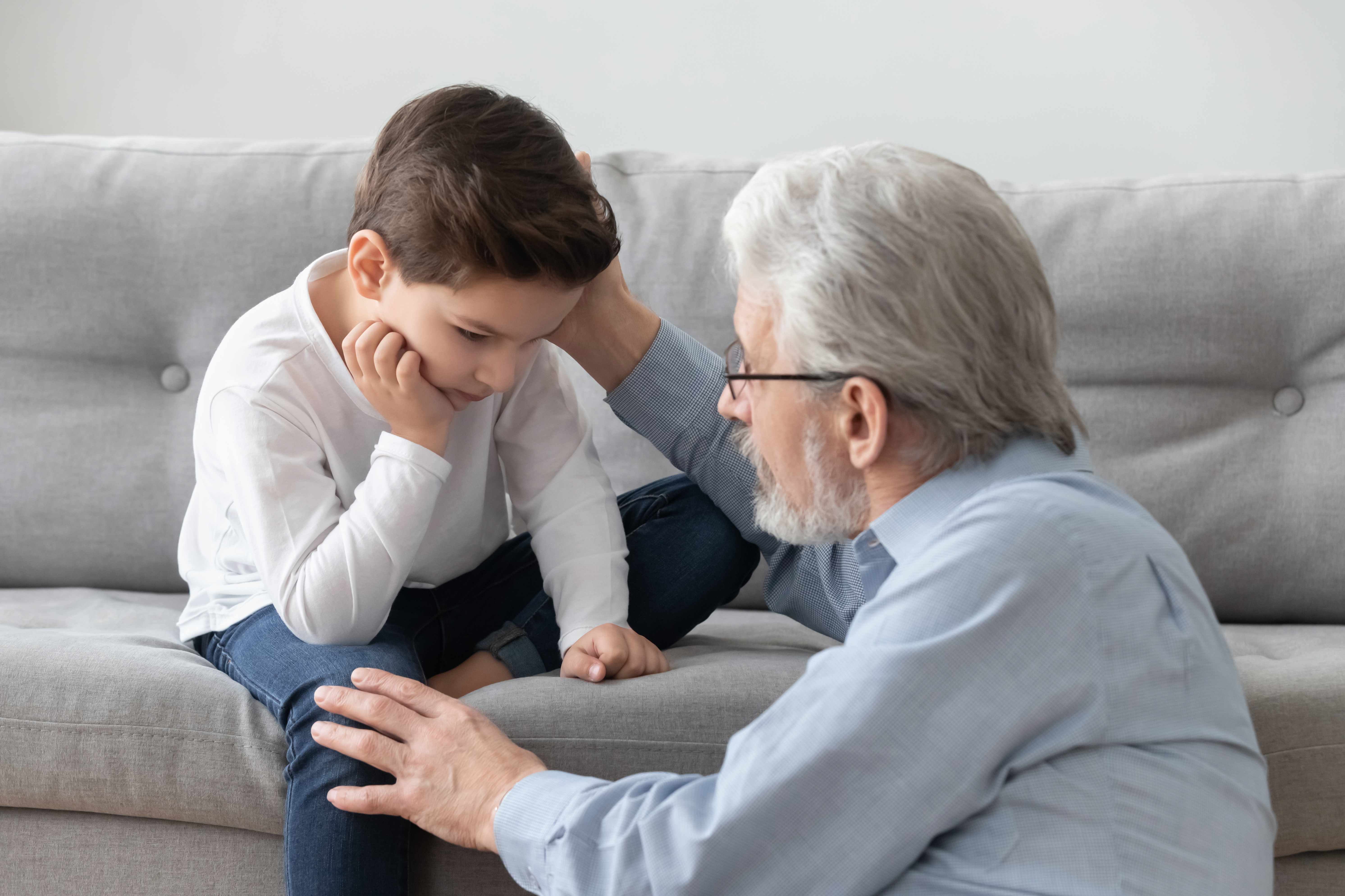 A grandfather hugging his grandchild | Source: Shutterstock