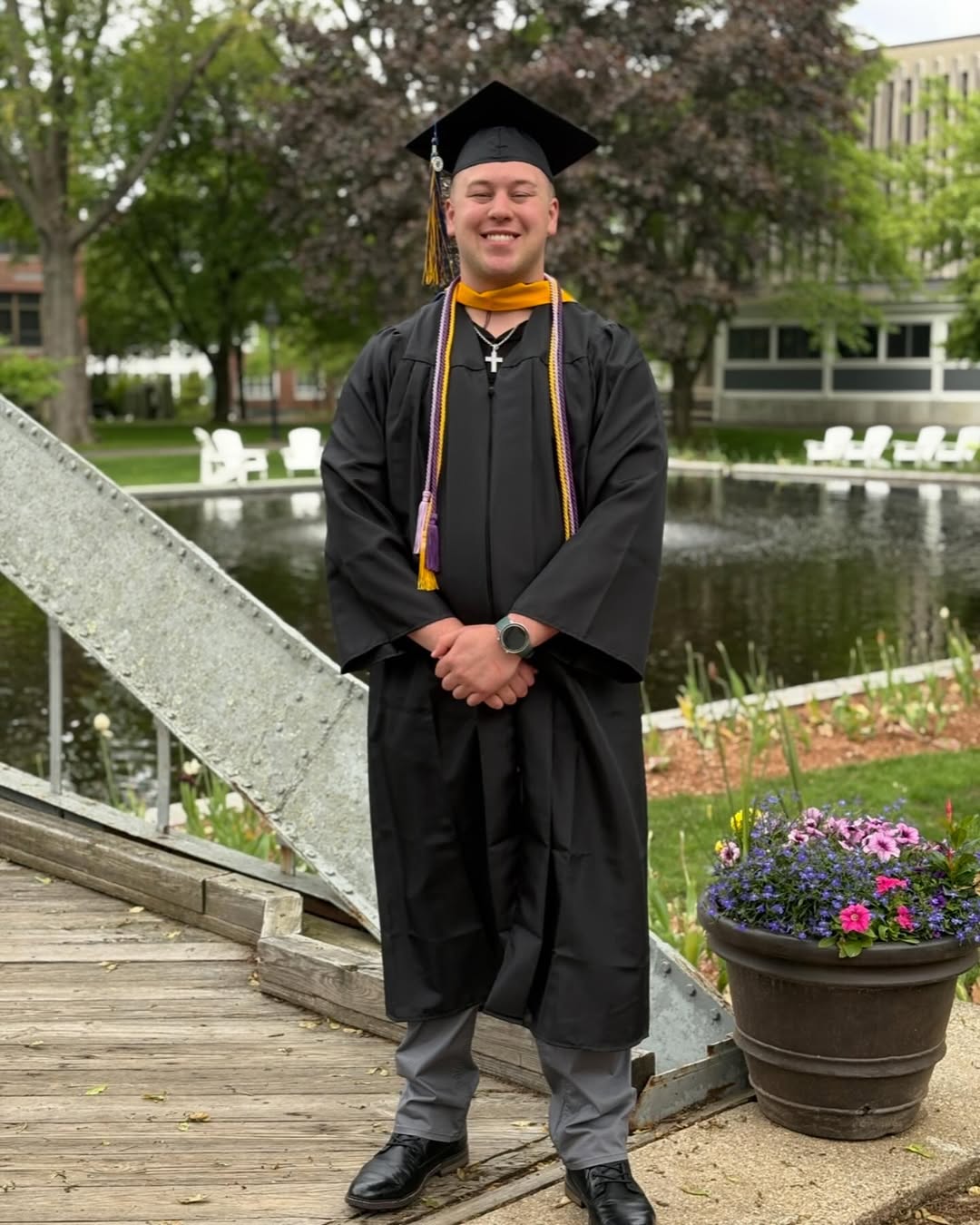 Aidan Dorgan poses in his cap and gown after completing his degree at Merrimack College | Source: Instagram/adawg_18