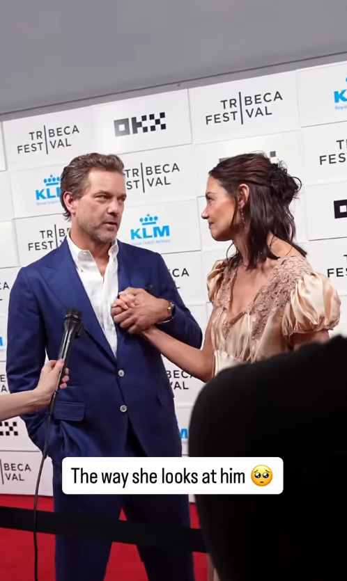 Joshua Jackson holds Katie Holmes' hand during an interview at the "Happy Hours" premiere during the 2026 Tribeca Festival in New York City. | Source: Instagram/hellocanadamag