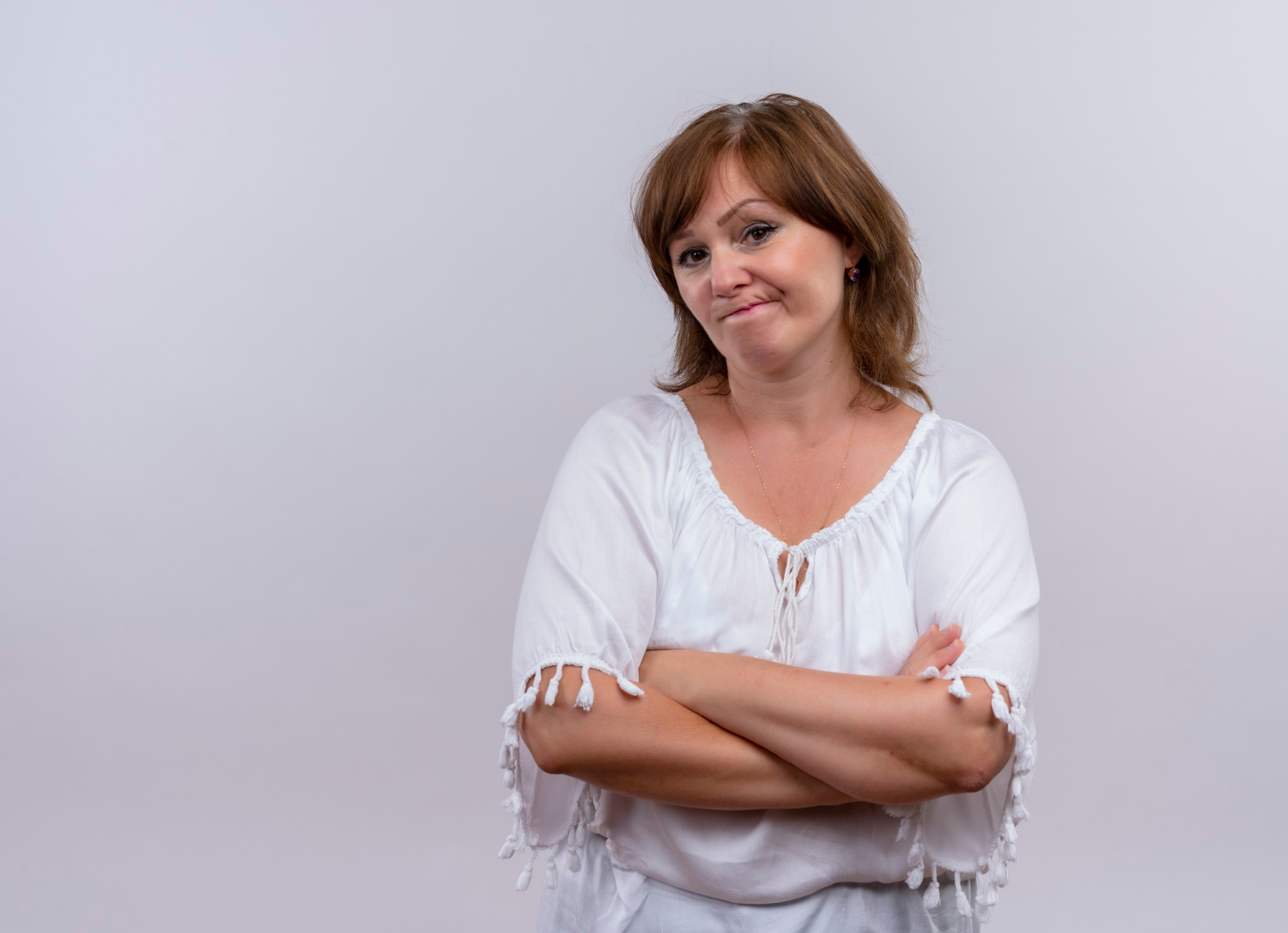 A senior woman with her arms crossed | Source: Freepik