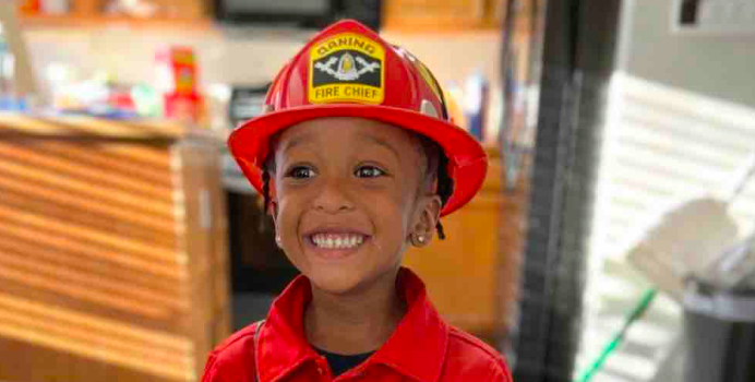 Elias Reliford smiling in a firefighter outfit, posted on March 15, 2026. | Source: GoFundMe/Support for Todd Reliford's Family After Tragedy