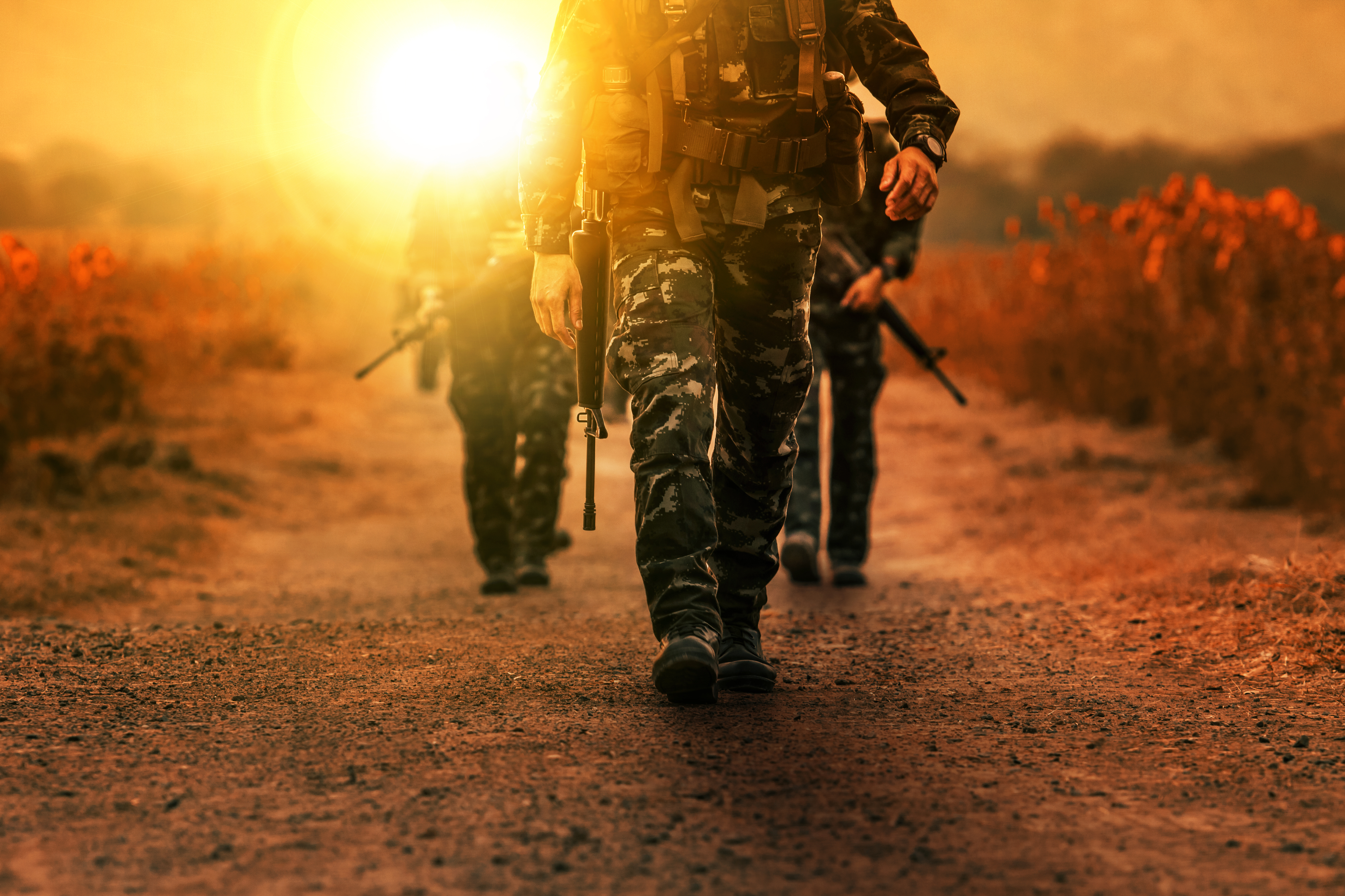 Troop with gun weapons of long range patrol army. | Source: Shutterstock