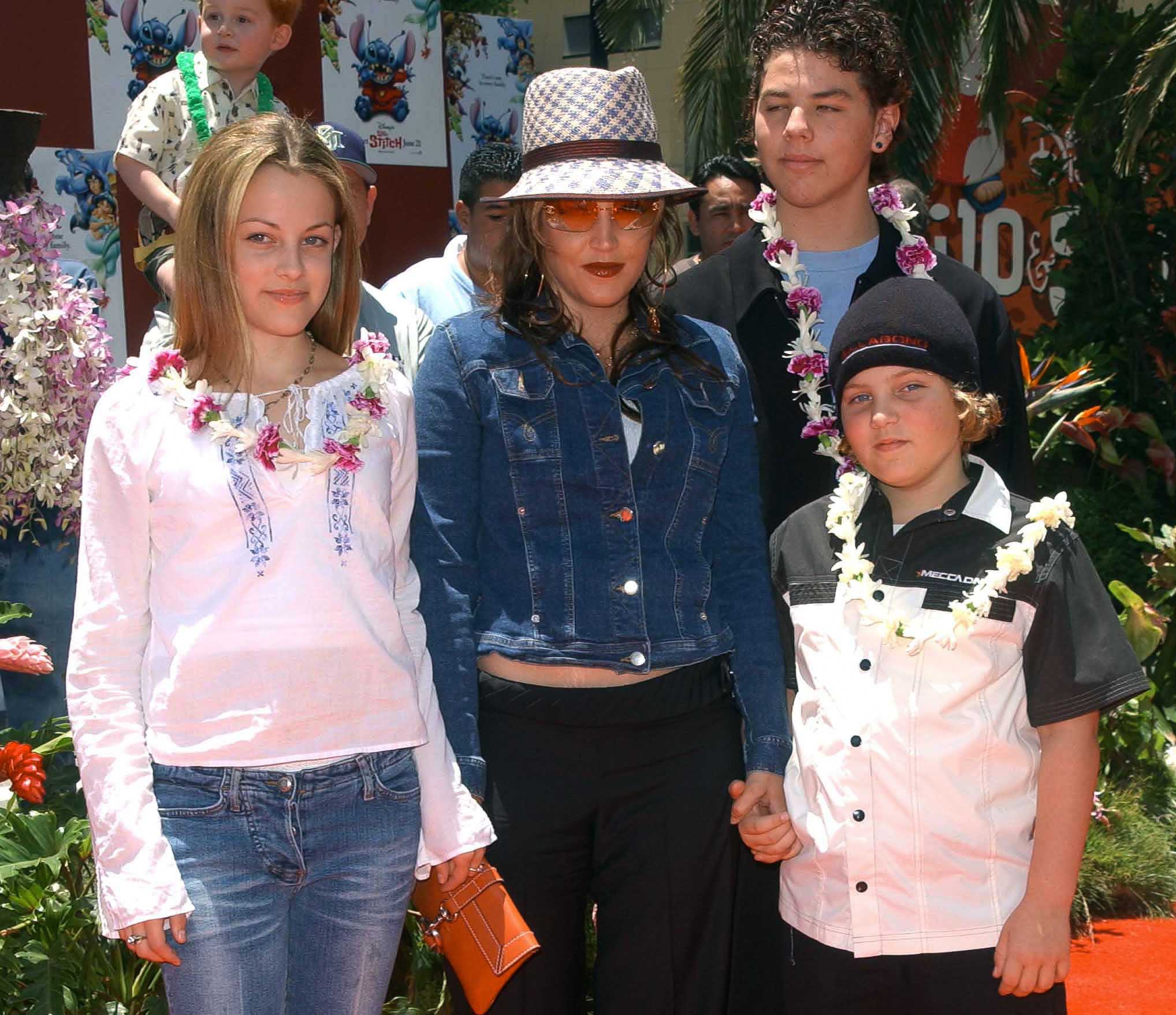 Lisa Marie Presley and her children Benjamin Keough (R), Riley Keough (L), and her half-brother Navarone Garibaldi (back) attend the premiere of "Lilo and Stitch" at the El Capitan theatre in Hollywood on June 16, 2002. | Source: Getty Images