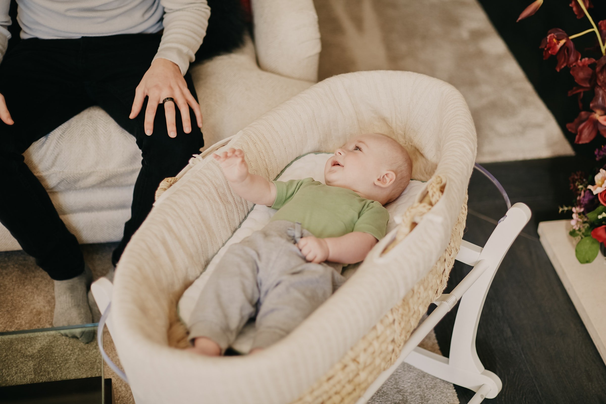 Person sitting beside a baby in a crib. | Source: Unsplash