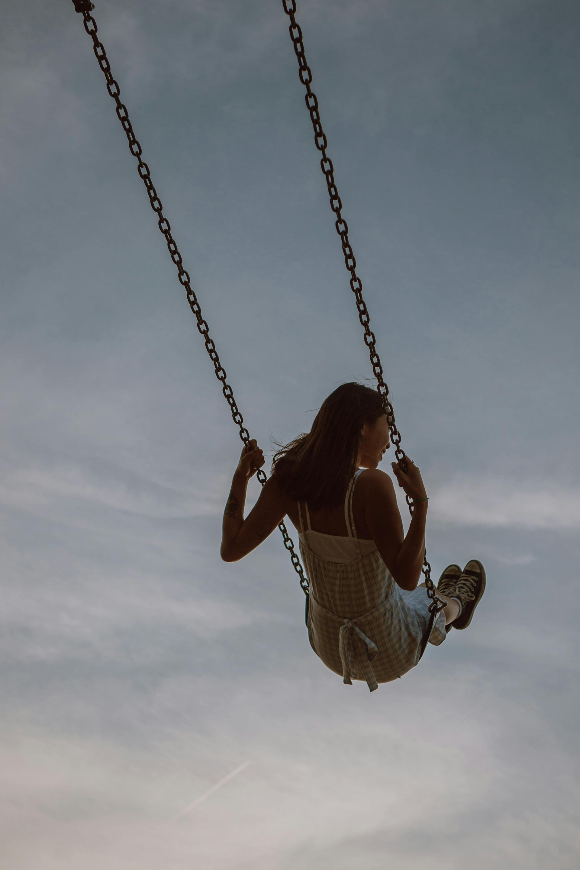 A woman taking a swing and enjoying the ride | Source: Pexels