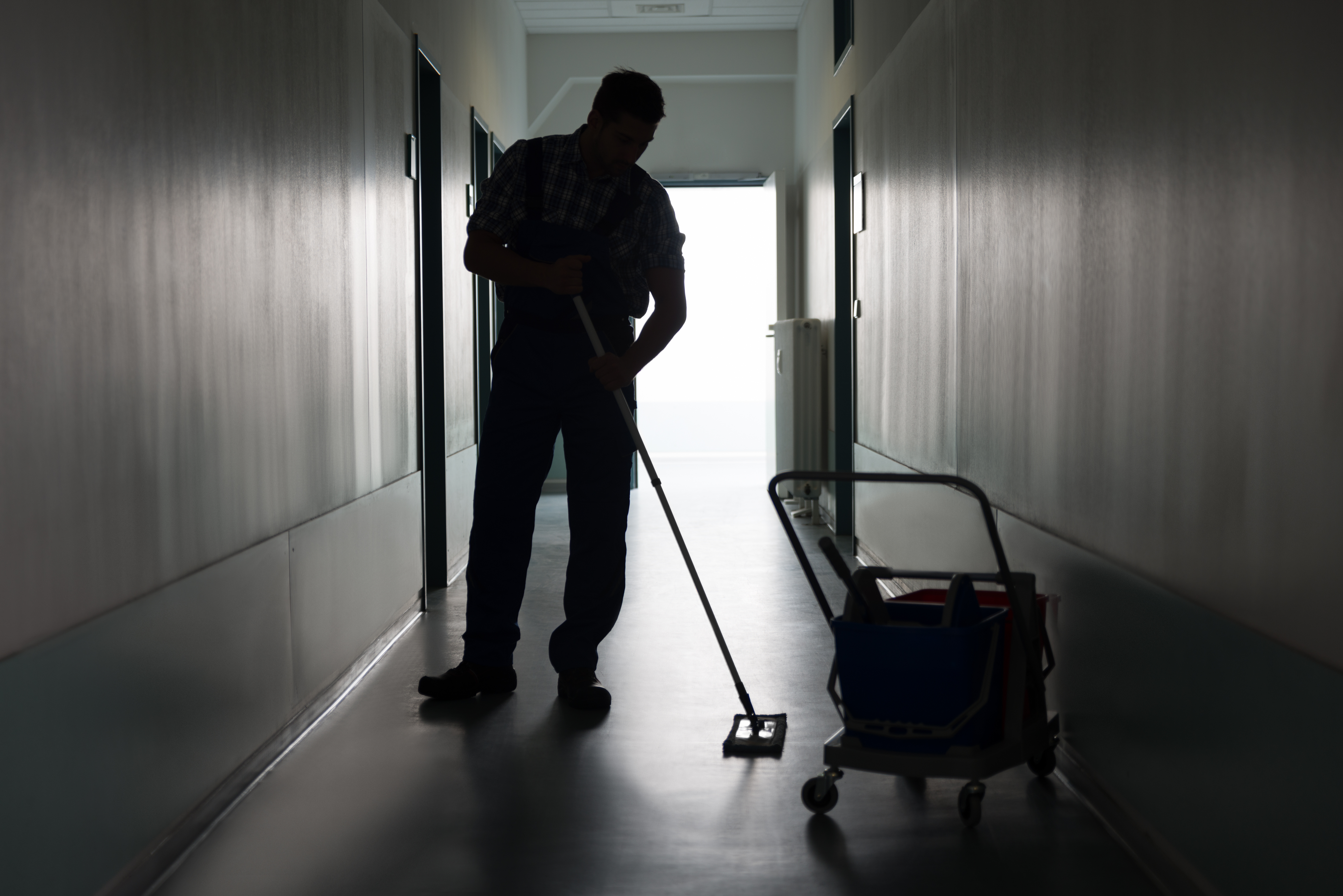 A janitor cleaning a corridor | Source: Shutterstock