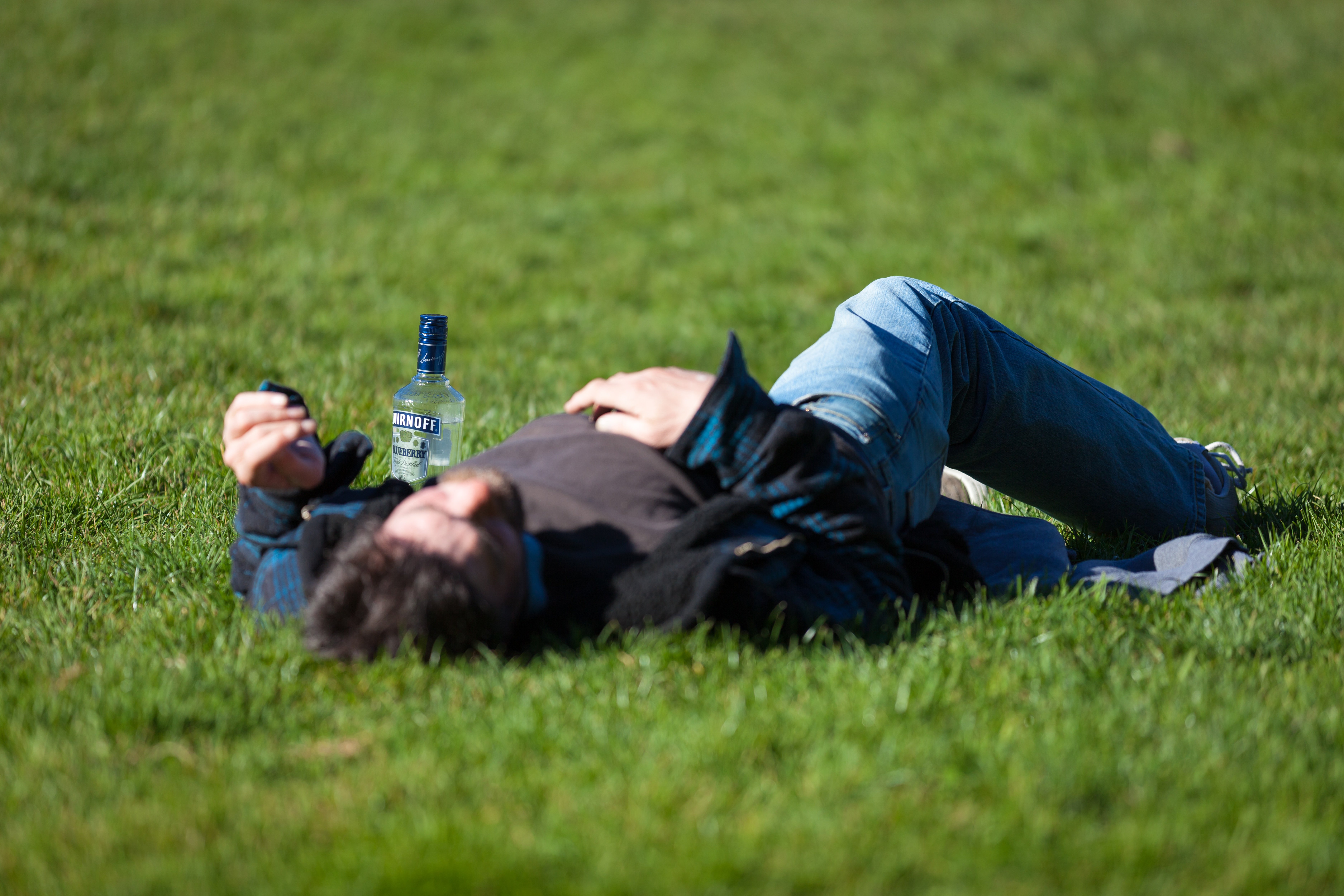 Drunk man passed out in a park. | Source: Unsplash