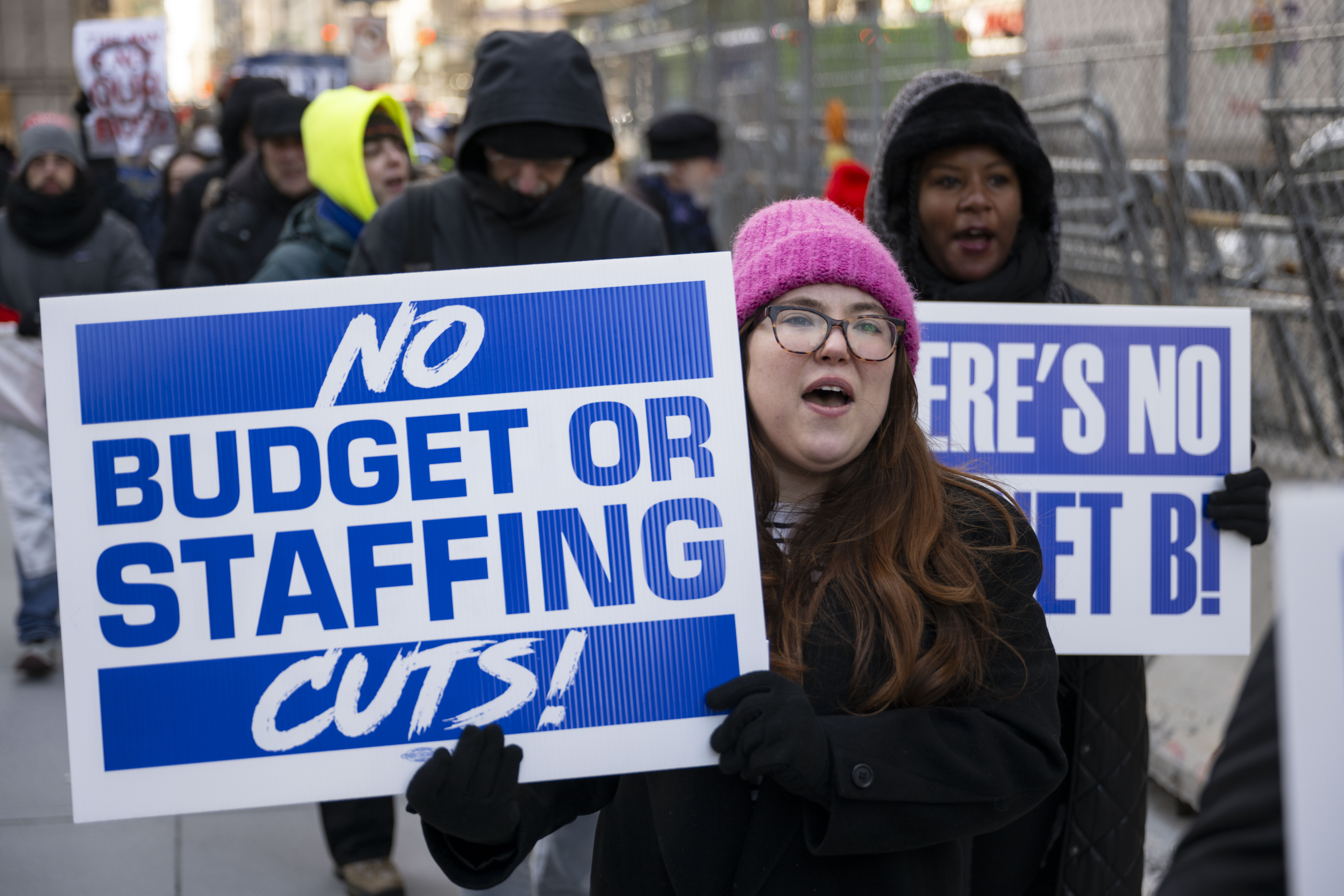 People holding banners chant during a rally outside Jacob K. Javits Federal Building against the firings of thousands of federal workers by President Donald Trump and Elon Musk's DOGE in New York City, on February 19, 2025 | Source: Getty Images