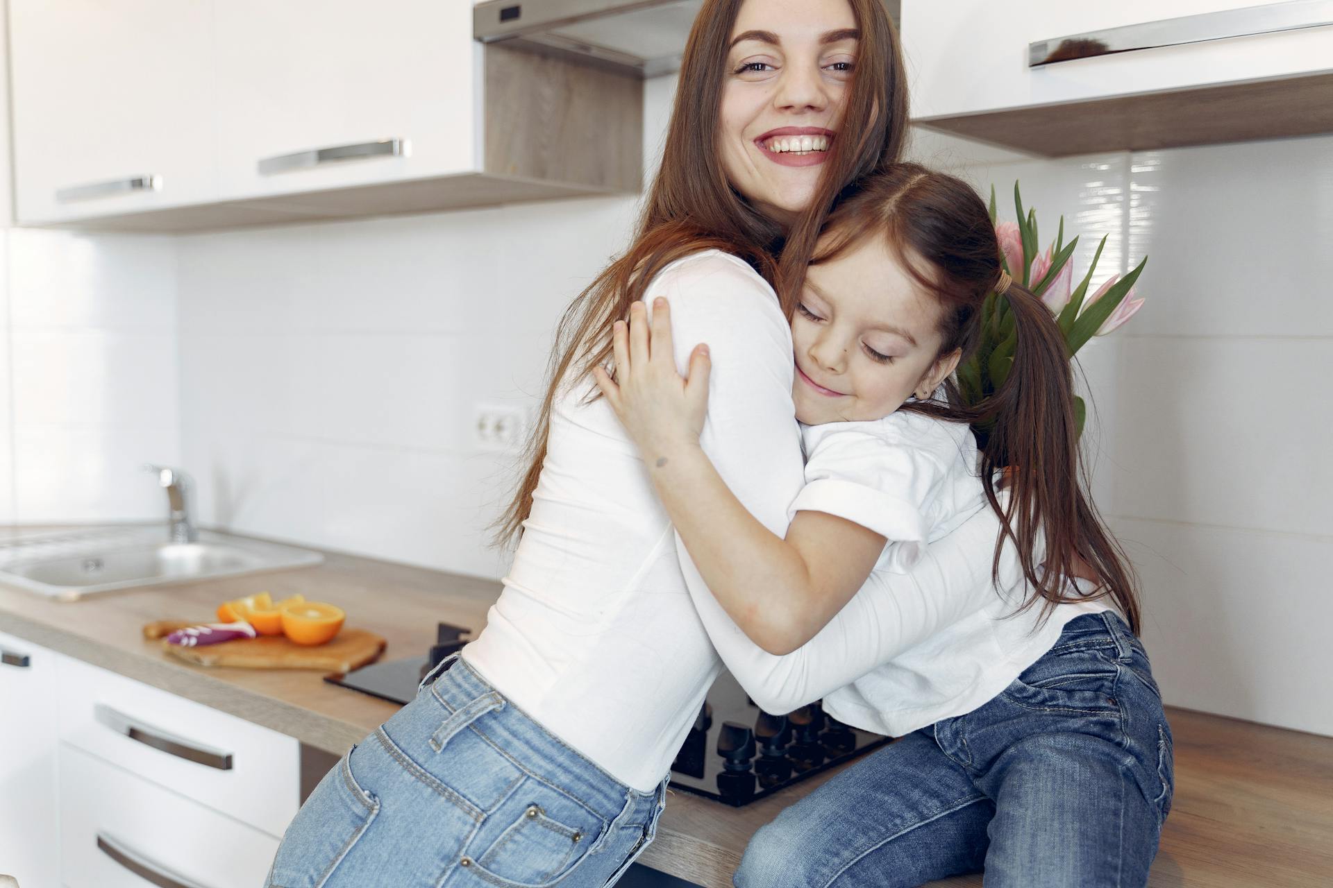 A woman hugging her daughter | Source: Pexels