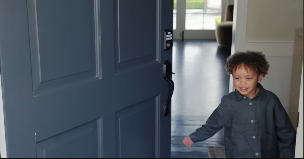 Palmer's three-year-old son let the camera crew into the house before running off to hide. | Source: YouTube/@Archdigest