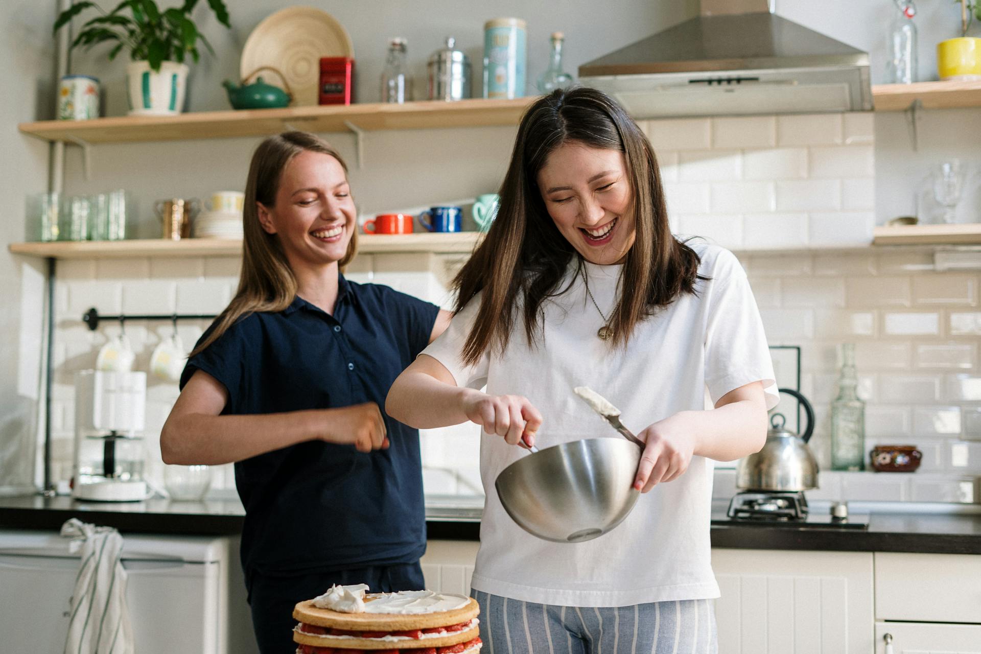 Two women preparing pancakes in the kitchen | Source: Pexels