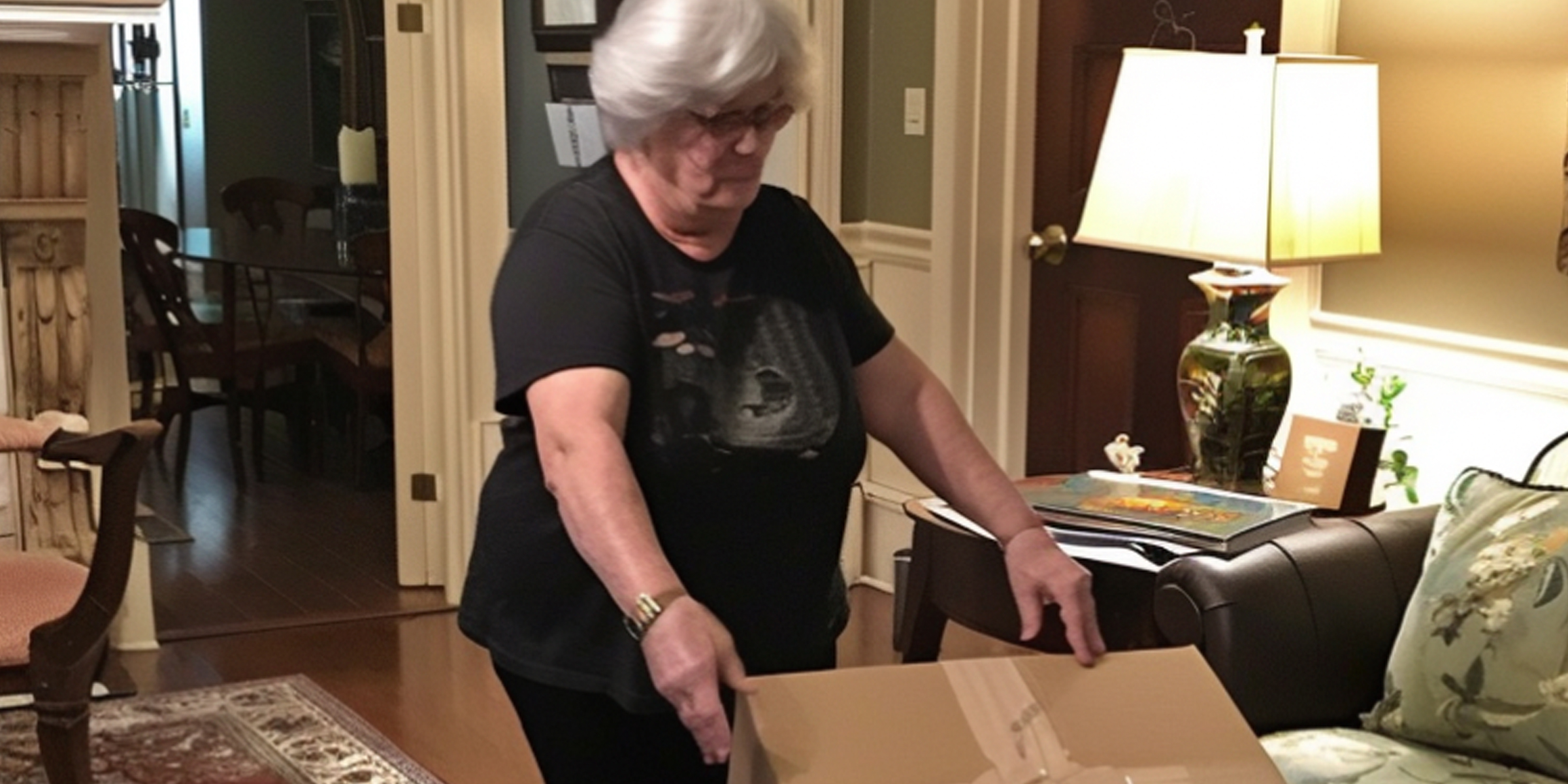 Elderly lady setting down a storage box in the living room | Source: Amomama