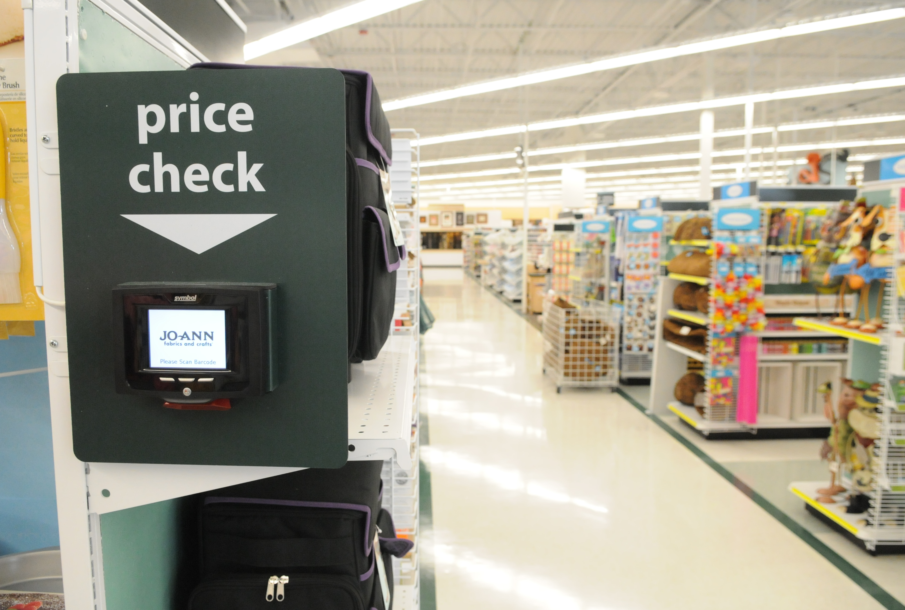 A Joann Fabrics store with a price check scanner and stocked aisles | Source: Getty Images