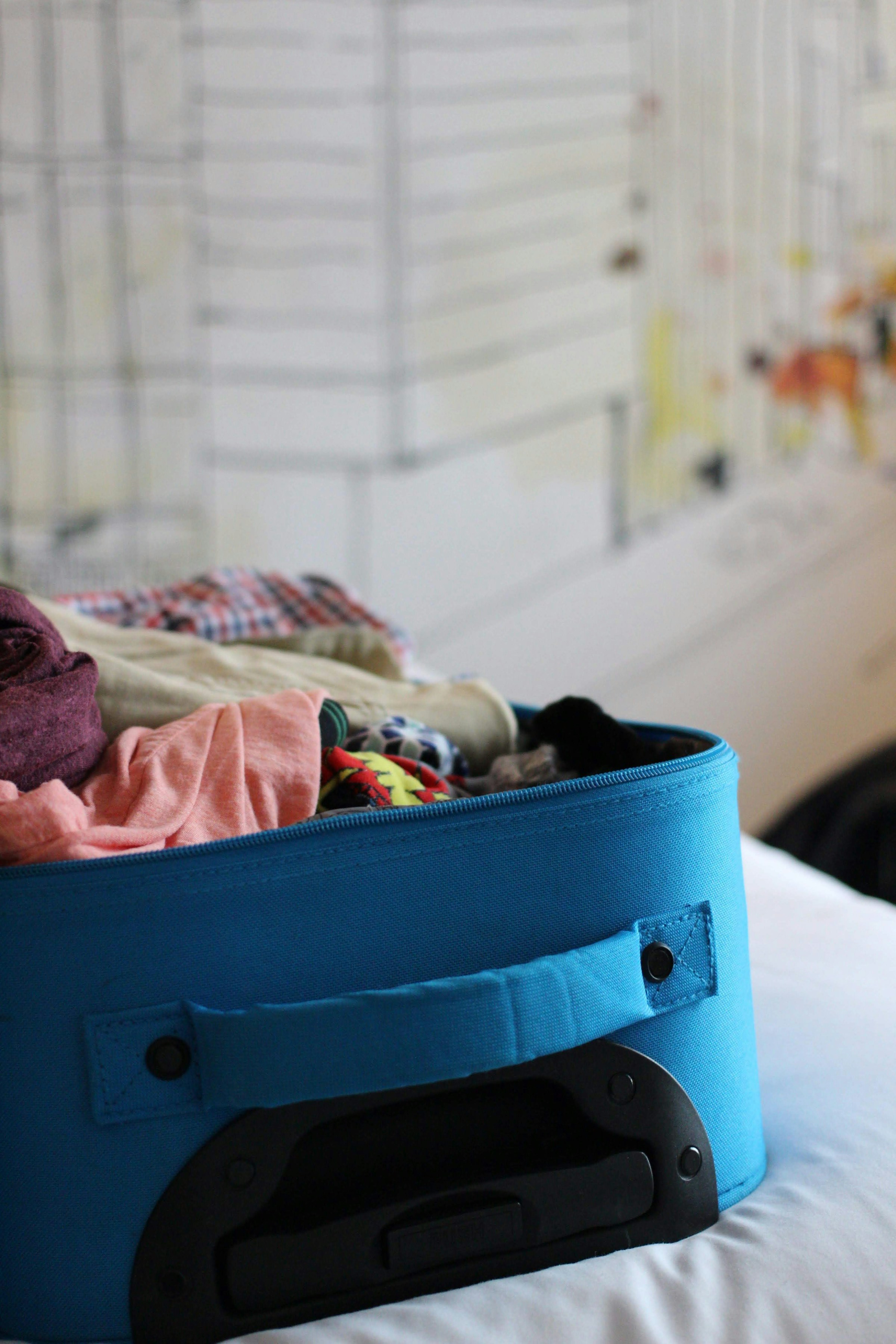 A suitcase stashed with clothes | Source: Unsplash