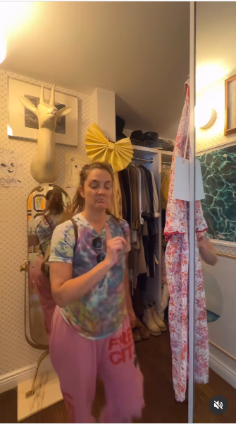 Drew Barrymore stepping out of one of the rooms in her house from a video posted on July 21, 2025 | Source: Instagram/drewbarrymore
