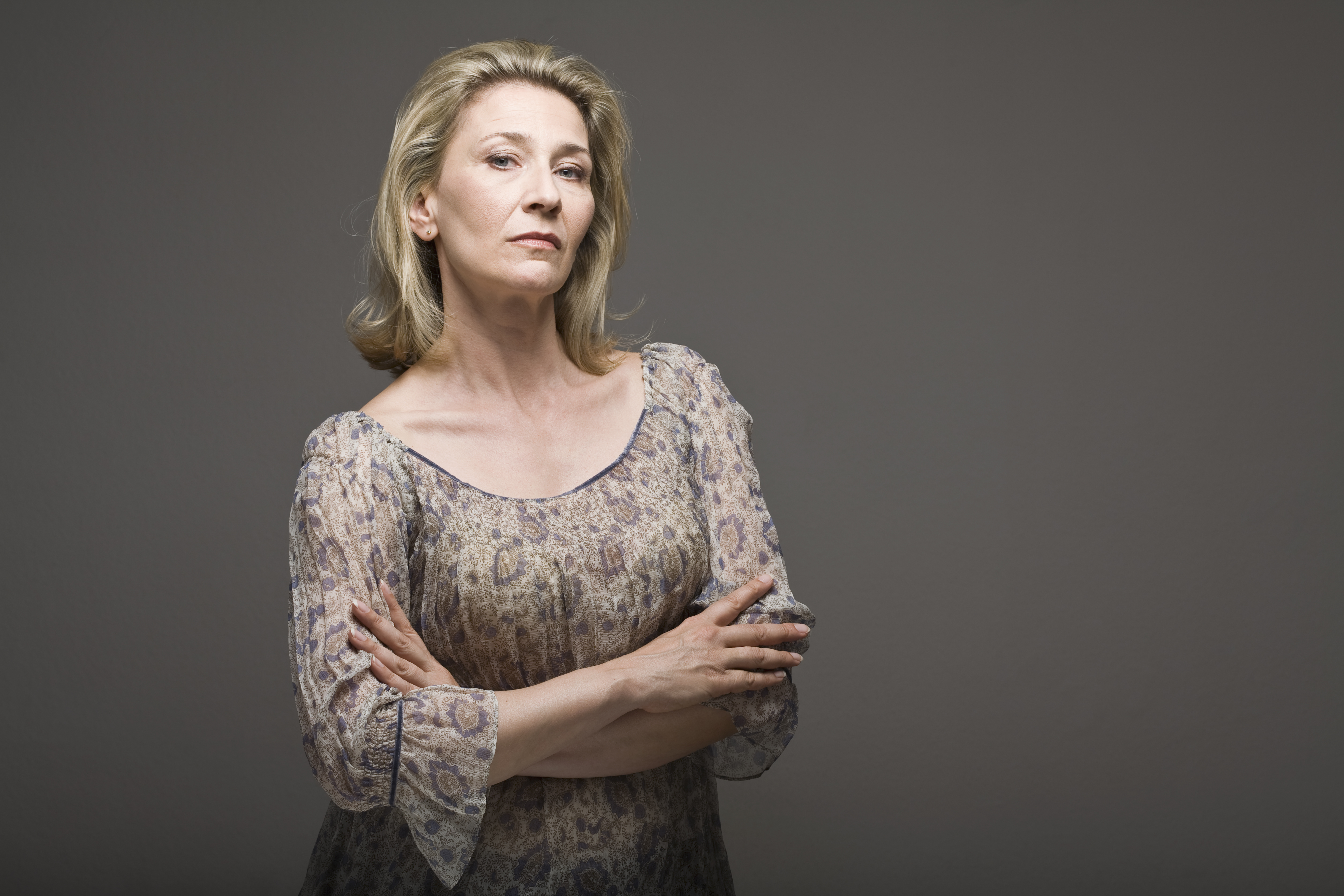 Angry middle-aged woman with arms crossed | Source: Getty Images