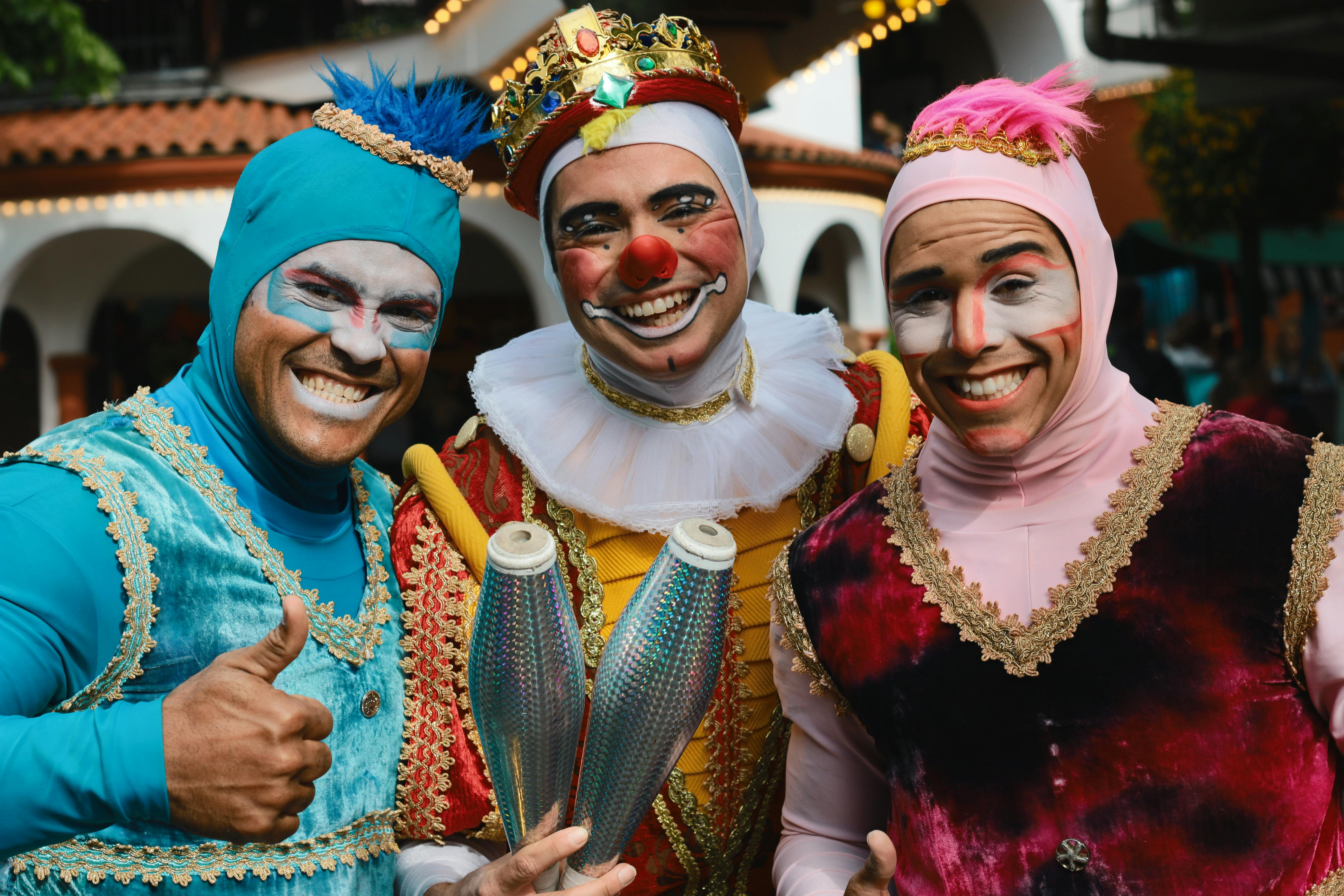 Outrageously-dressed people pose outside a house | Source: Pexels