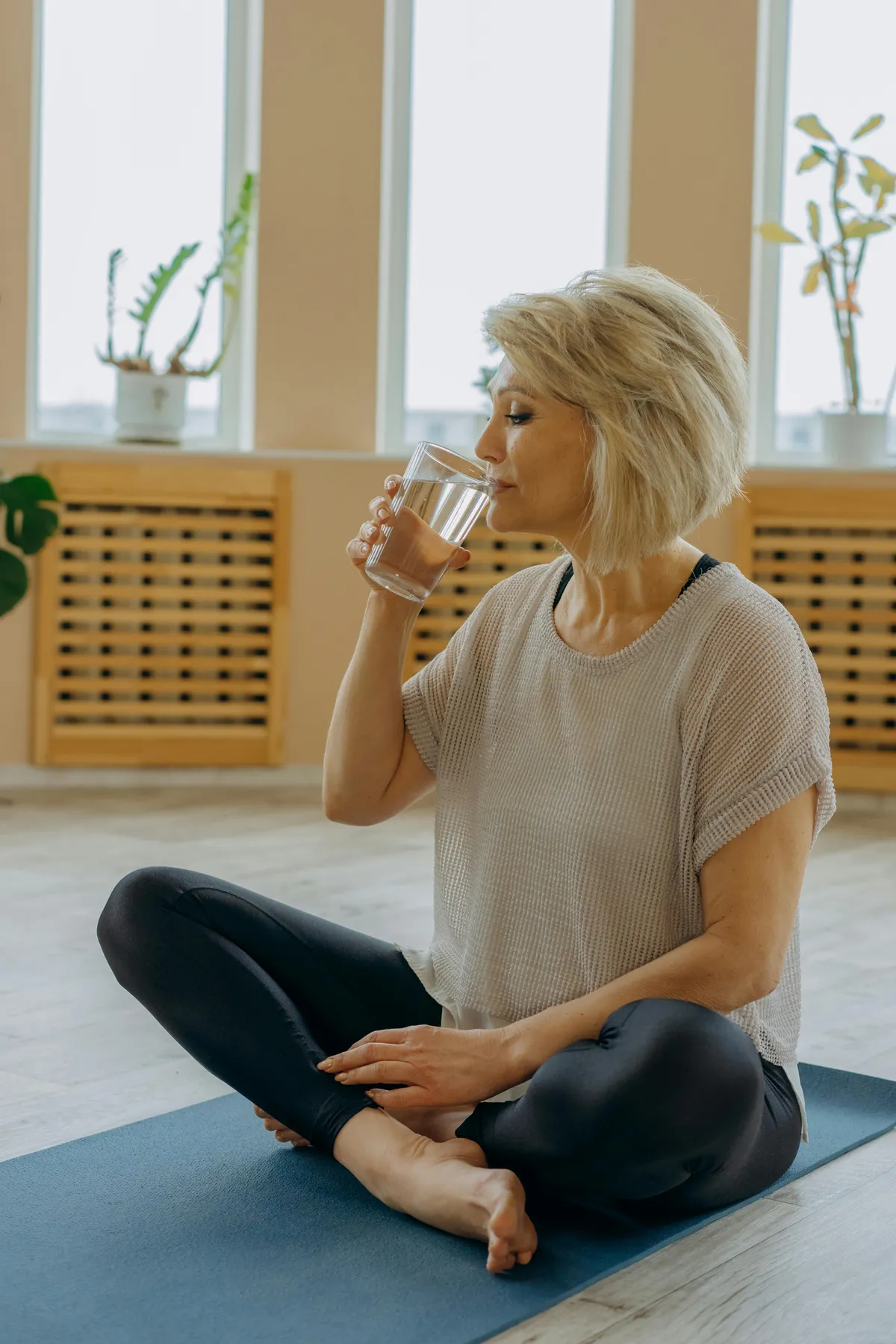 A woman taking a sip of water | Source: Pexels