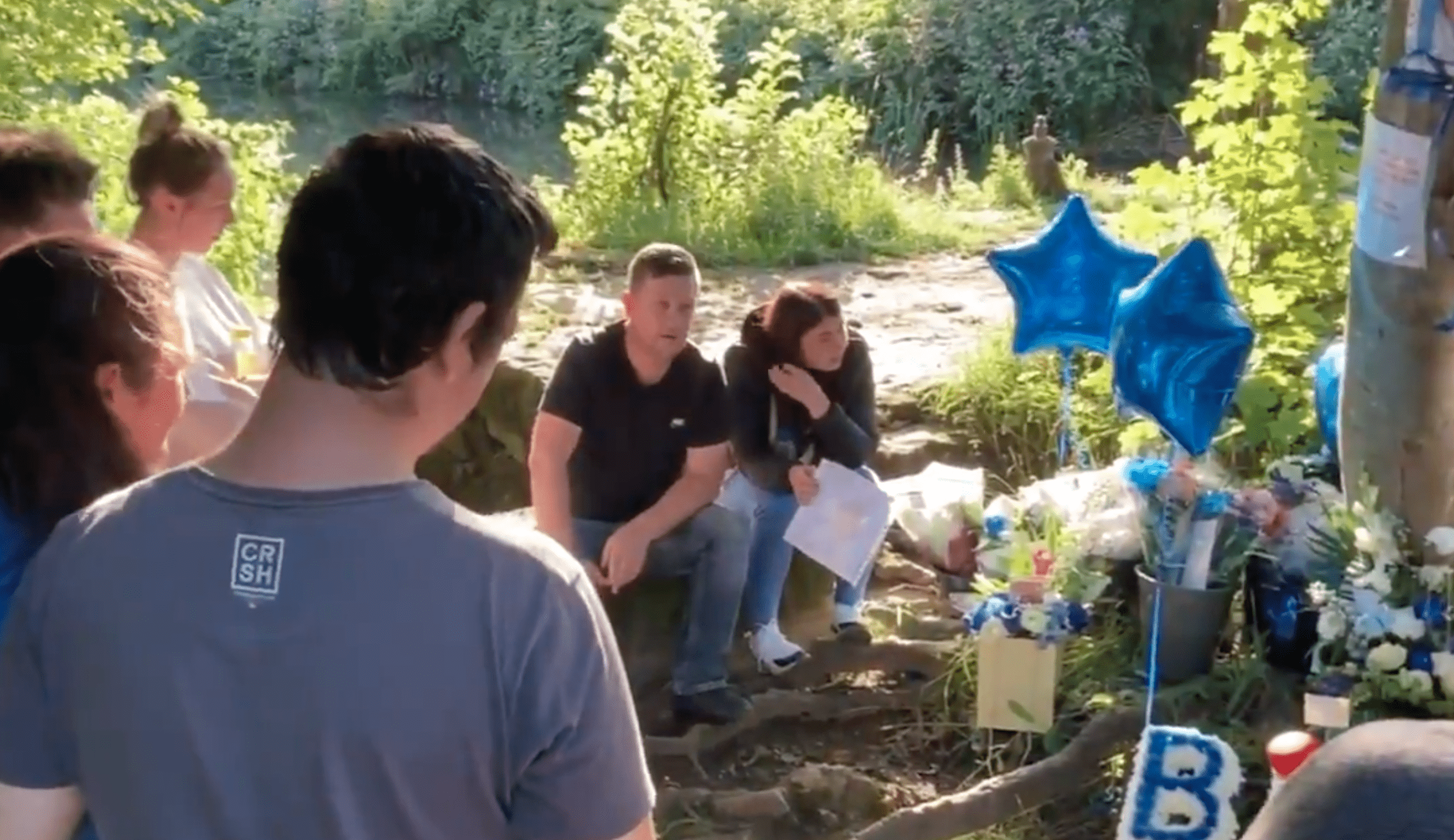 Loved ones gather next to a canal with balloons and cards to honor a young boy who drowned | Photo: Twitter/GHR_Derbyshire