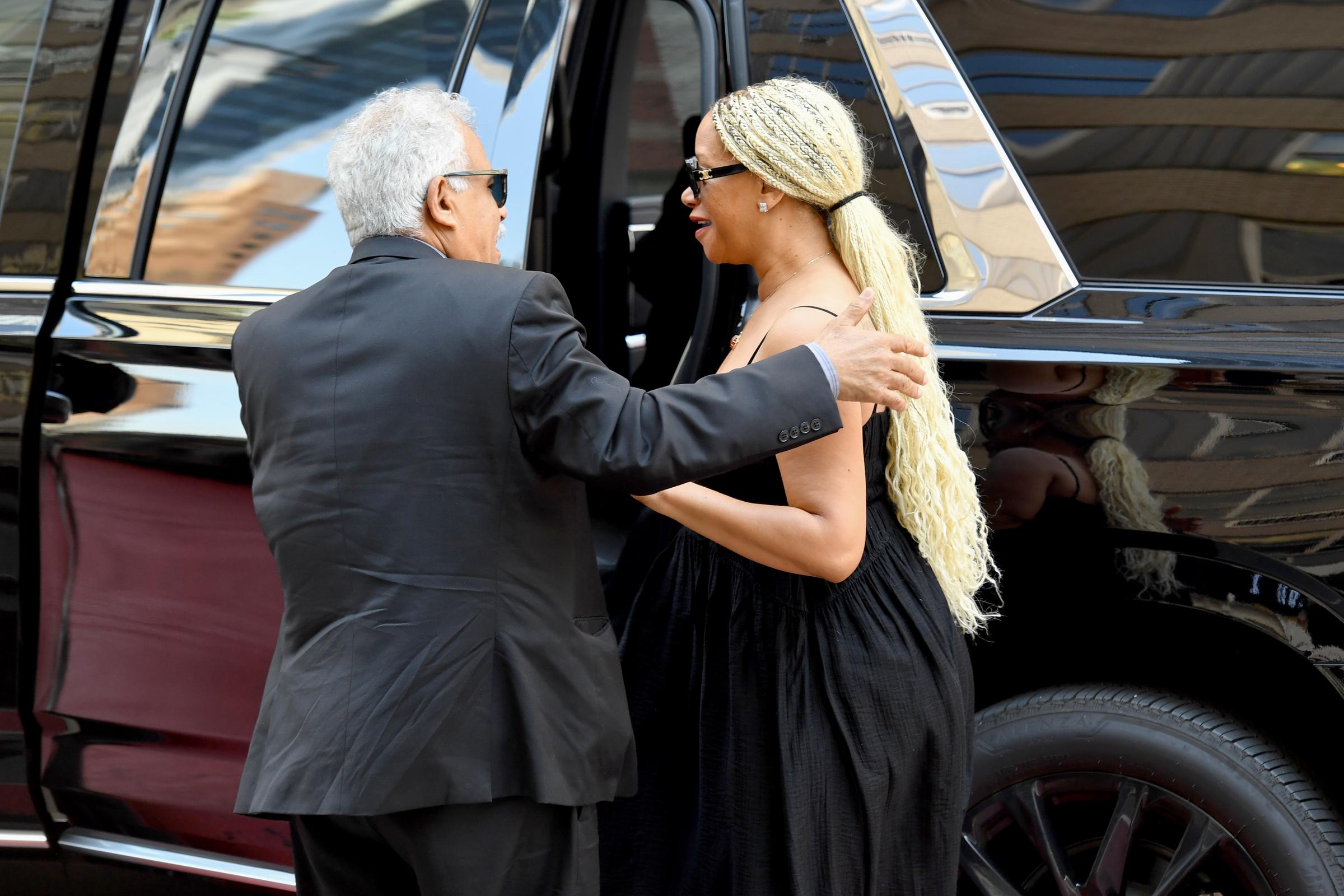 Guests embraced and exchanged greetings outside the venue before Clive Davis' memorial service began, including Tomeeka Robyn Bracy. | Source: Getty Images
