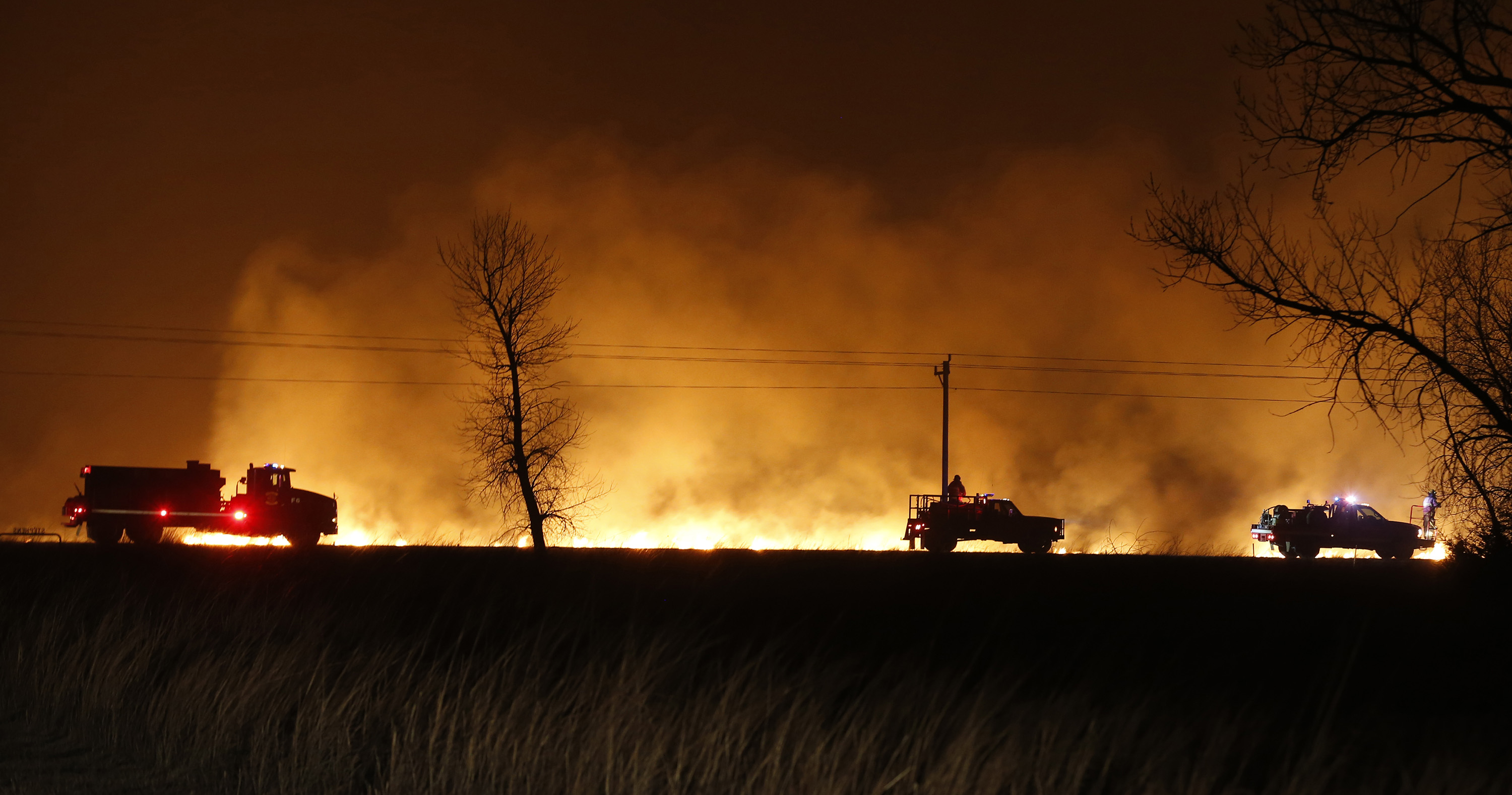 Firefighters from across Kansas and Oklahoma battle a major wildfire near Protection, Kan, on March 7, 2017 | Source: Getty Images