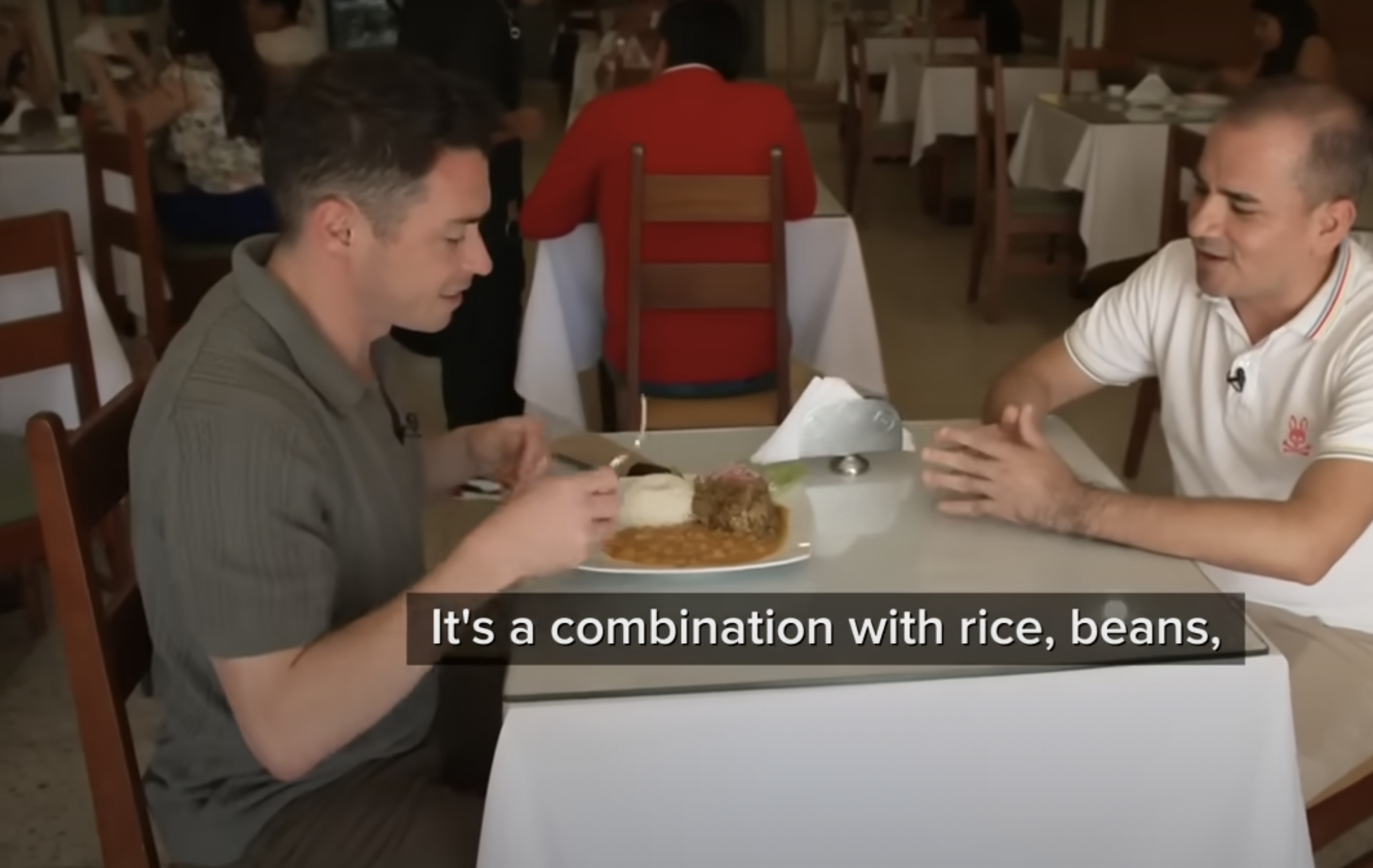 A screenshot of a reporter enjoying the simple dish of rice, beans, and goat meat, Pope Leo XIV's favorite, from a video dated May 13, 2025. | Source: YouTube/ABC News