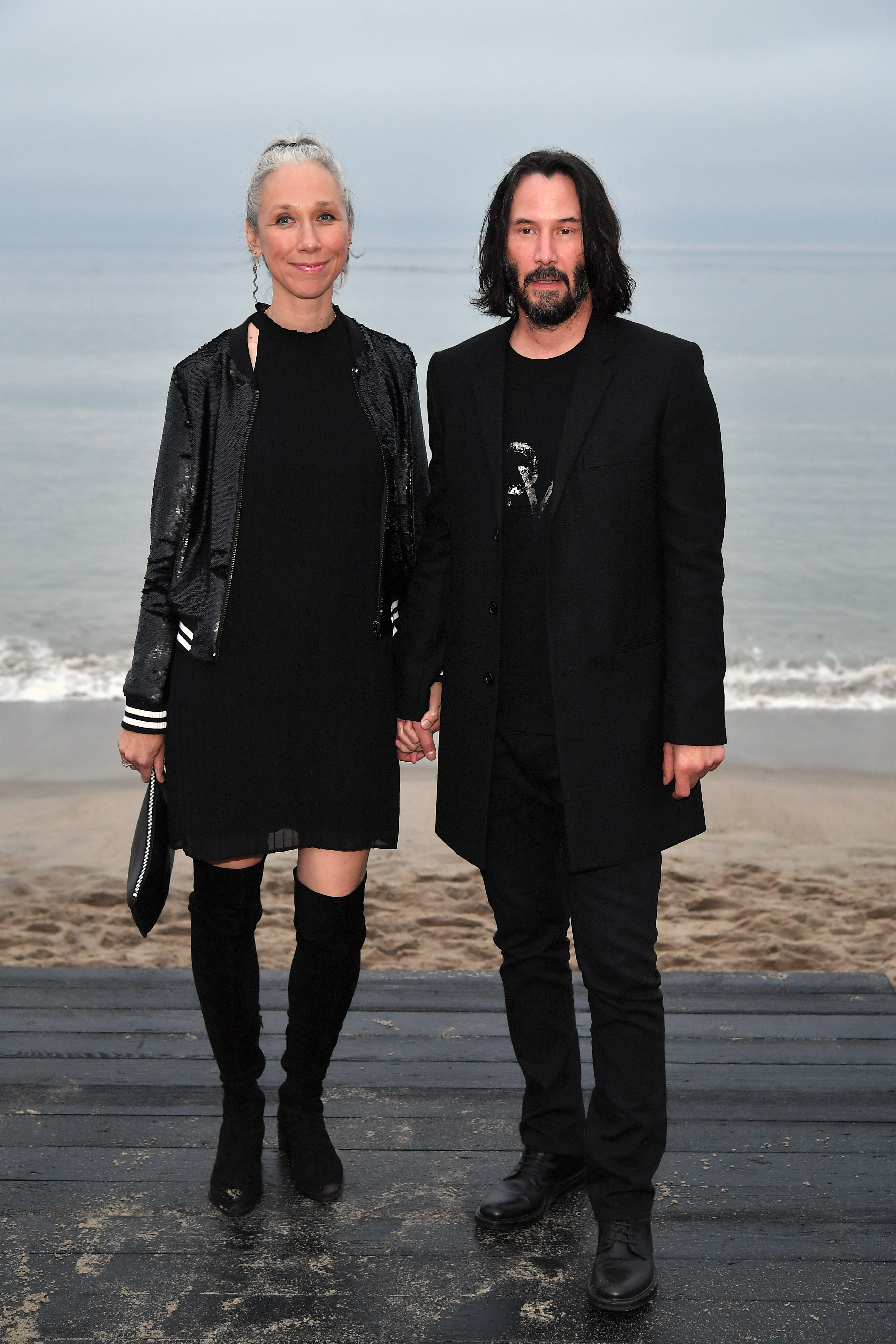 Alexandra Grant and Keanu Reeves at the Saint Laurent Mens Spring Summer 20 in California in 2019 | Source: Getty Images