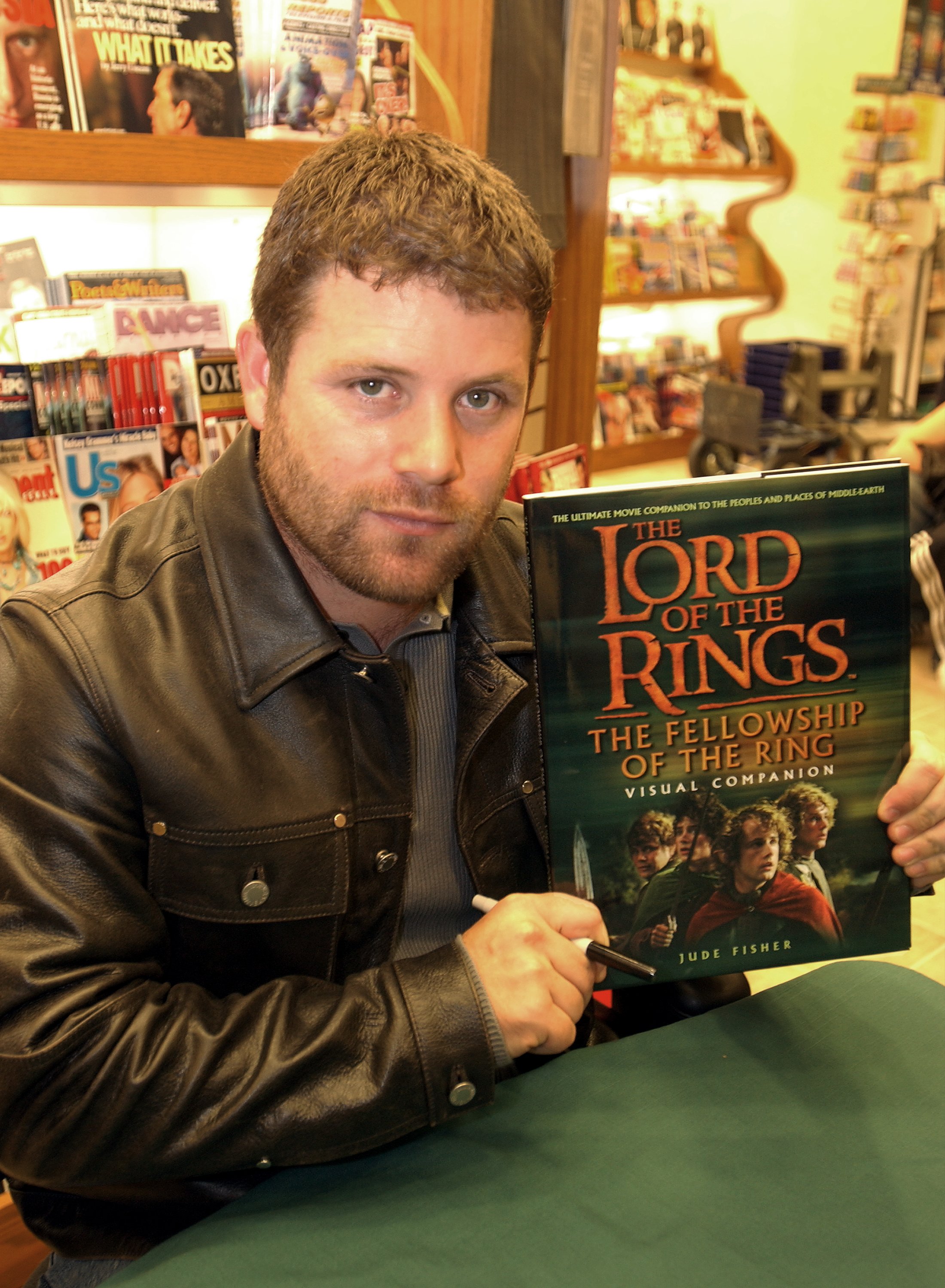 Sean Astin holds a copy of "The Lord of the Rings" during a promotional event for the film at Brentano's Bookstore in Los Angeles, California, on November 8, 2001. | Source: Getty Images