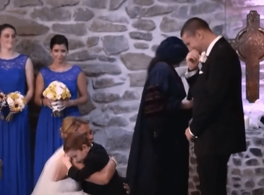 A groom is emotional as his bride dedicates part of her vows to his son | Source: Youtube/InsideEdition