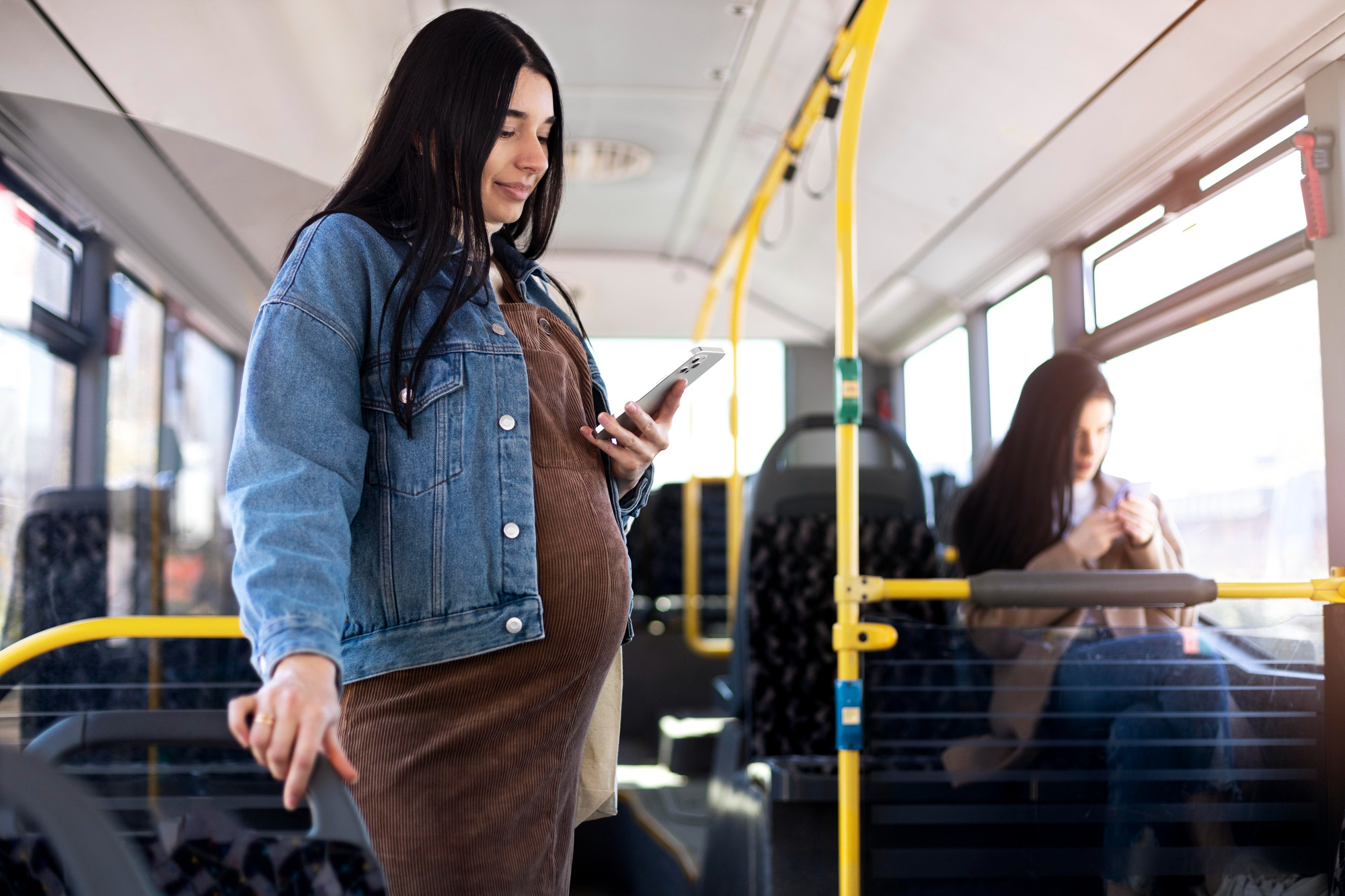A pregnant woman traveling by bus | Source: Freepik