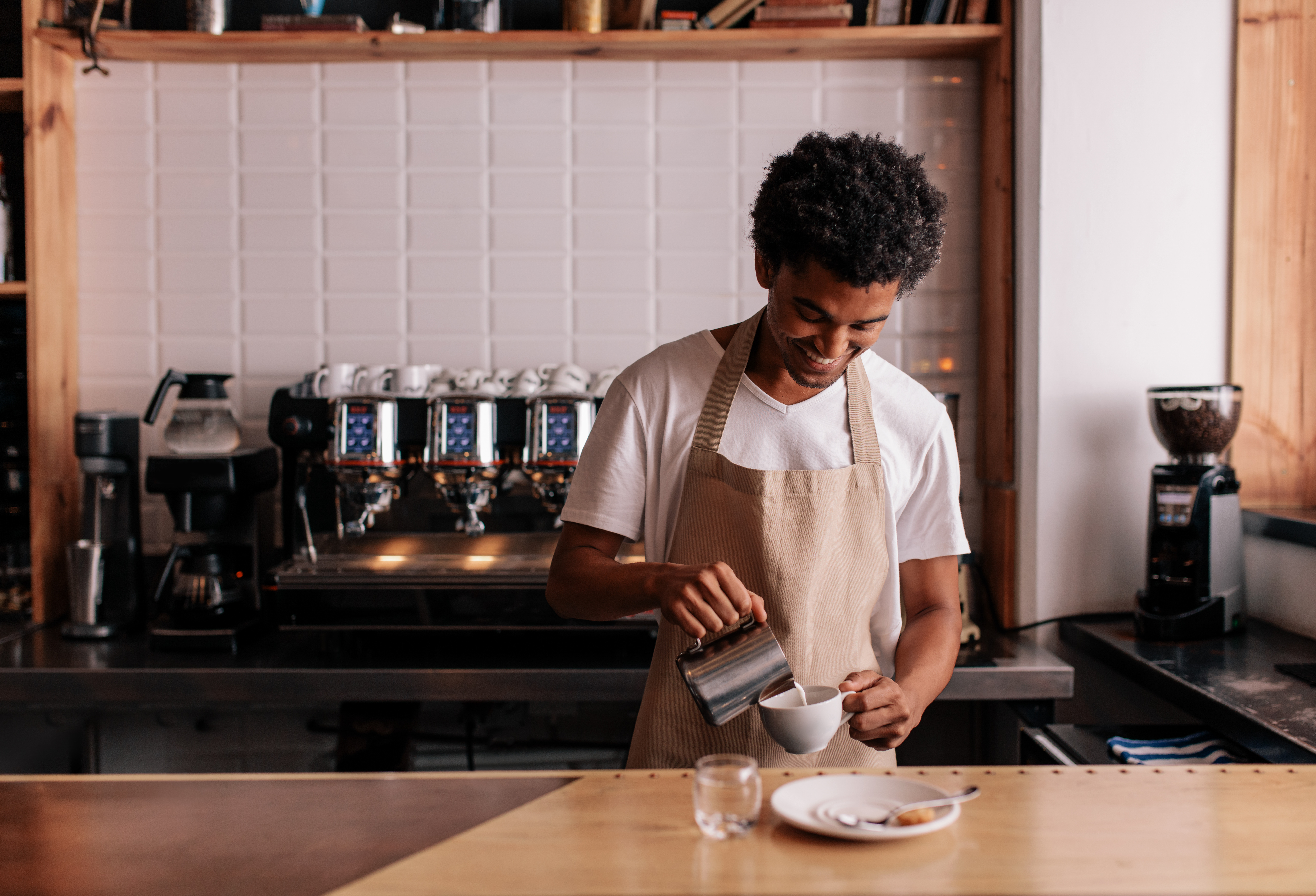Professional barista preparing coffee on counter. | Source: Shutterstock