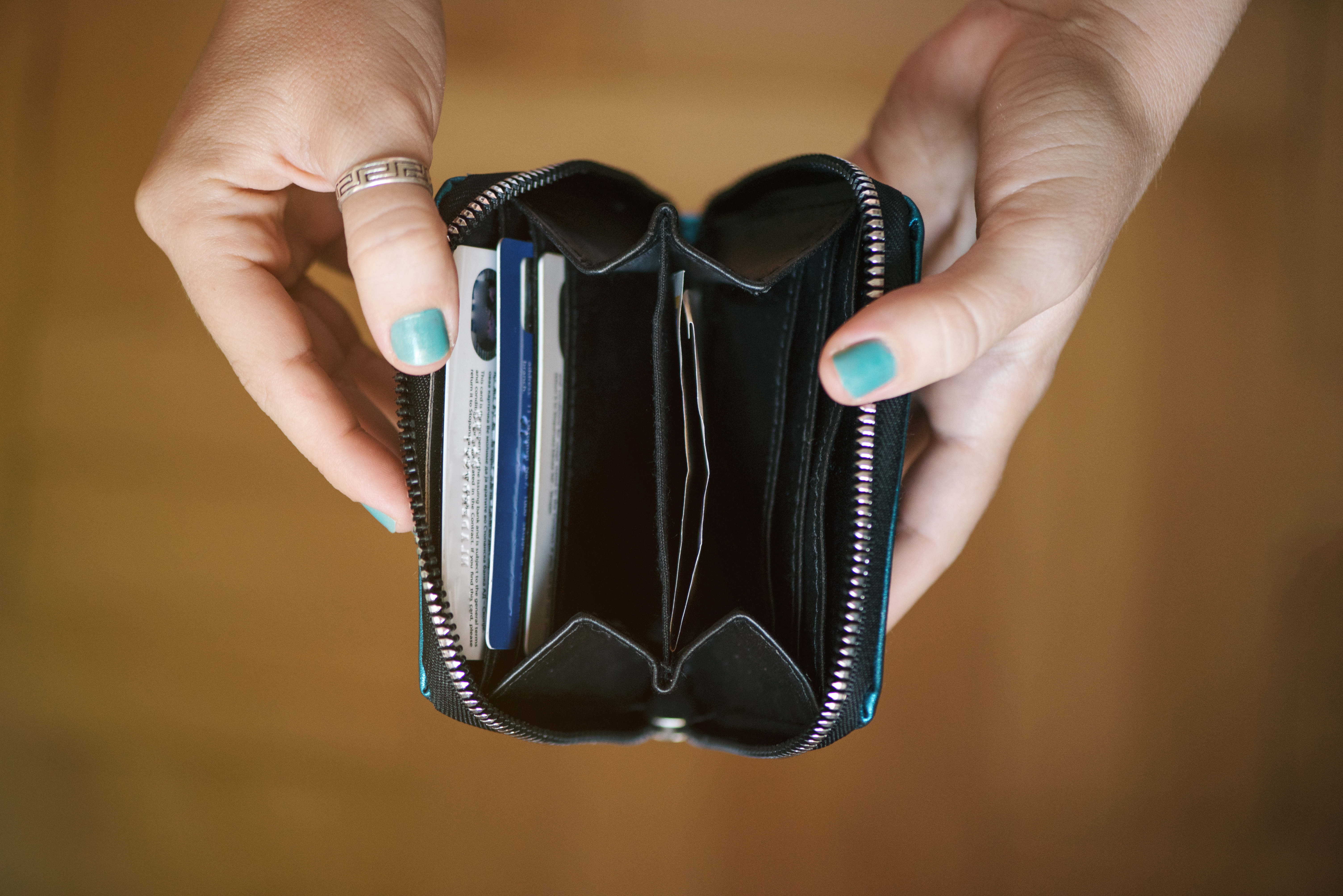 A woman holding an empty wallet | Source: