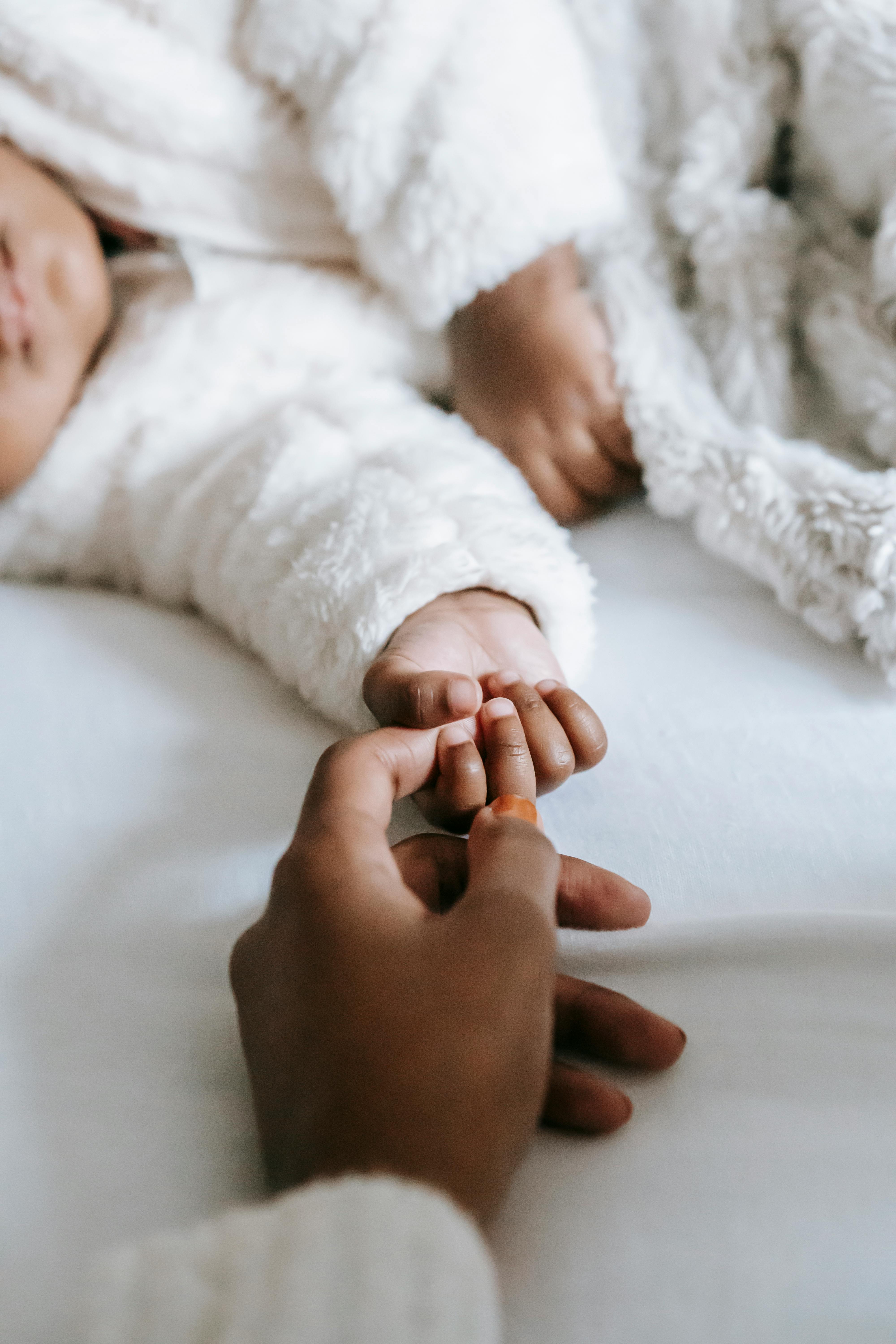 A person touching a baby's hand | Source: Pexels