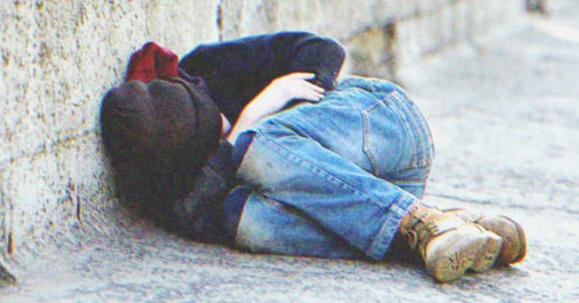 A kid laying on the street | Source: Shutterstock