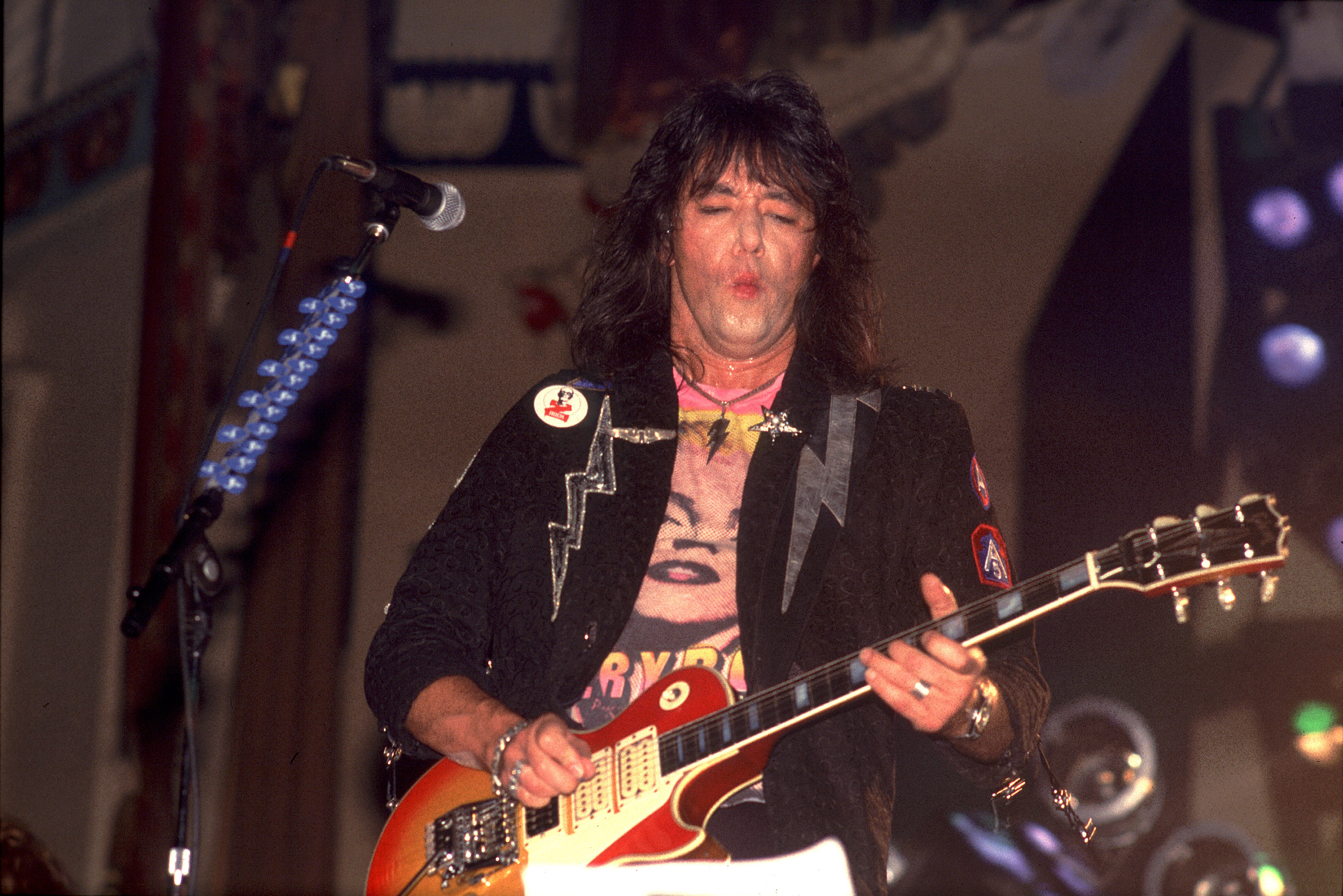 Ace Frehley plays guitar as he performs on stage at the Aragon Ballroom, in Chicago, Illinois, on September 4, 1987 | Source: Getty Images