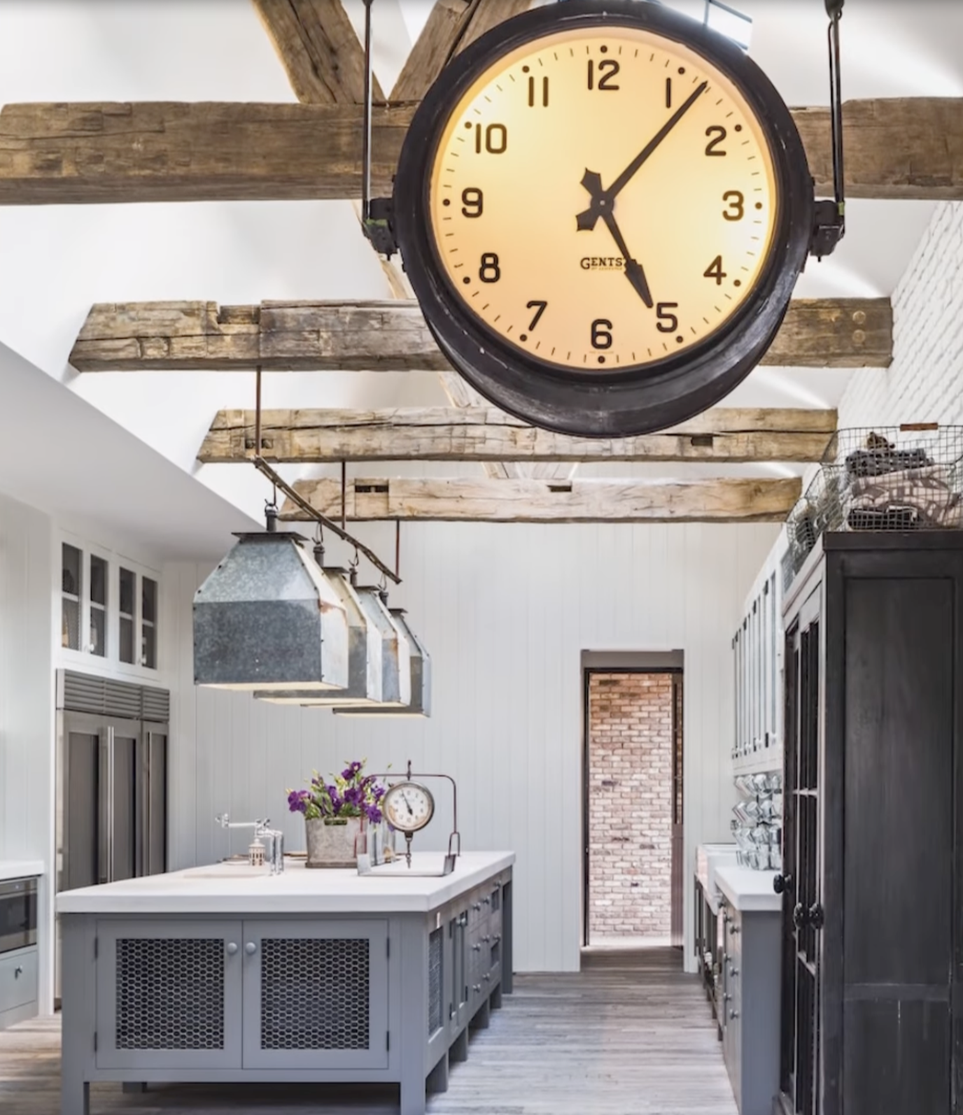 Kitchen interior featuring exposed wood beams and vintage clocks inside Diane Keaton’s Sullivan Canyon home, dated February 3, 2022 | Source: YouTube/@FamousEntertainment500k