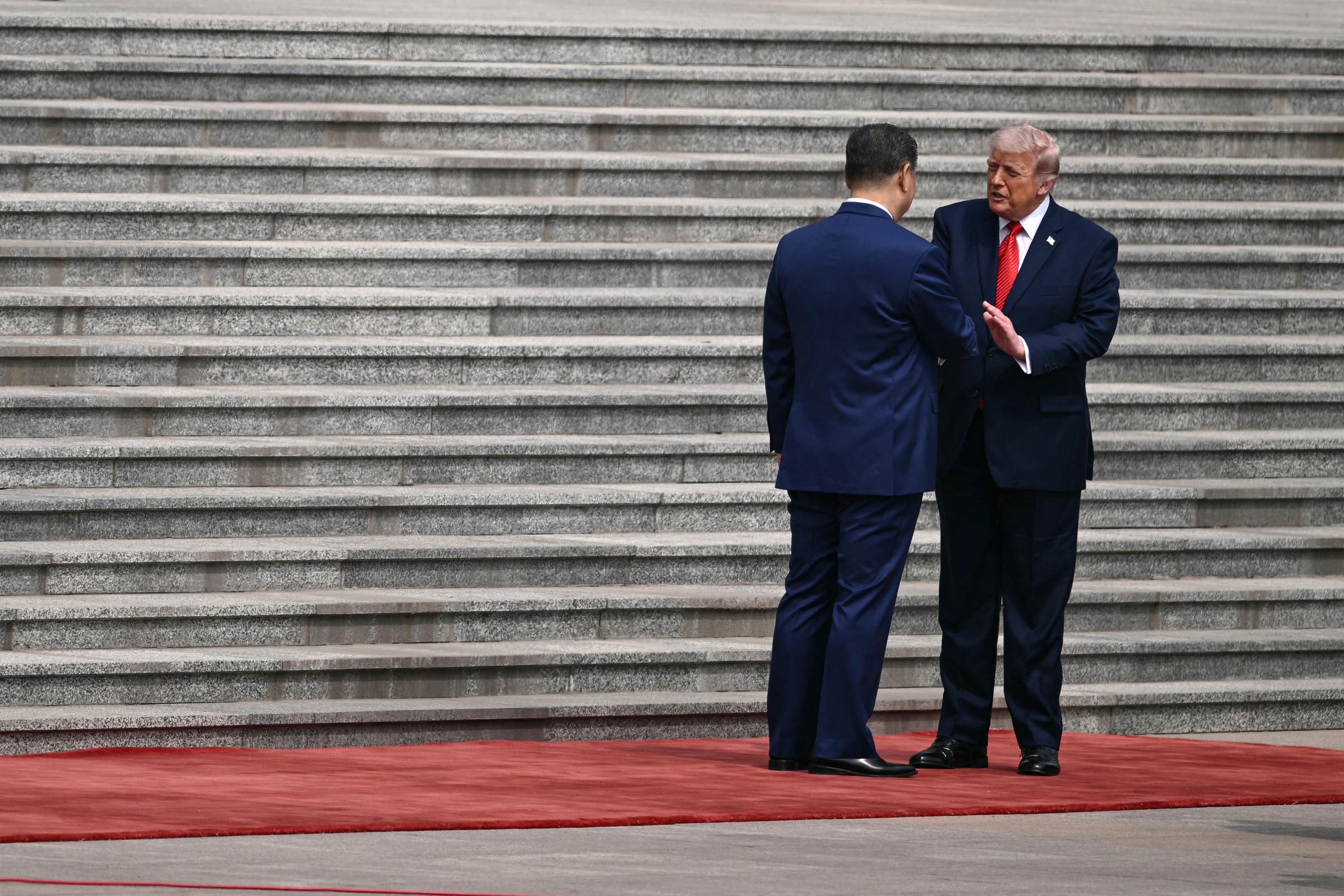 President Donald Trump leans in as he shakes hands with President Xi Jinping in Beijing, China, on May 14, 2026. | Source: Getty Images