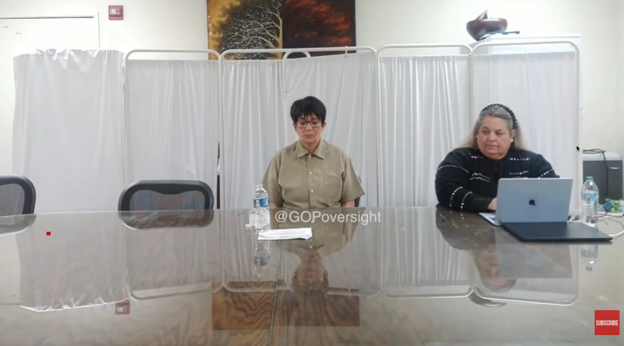 Streaming From Behind Bars: Maxwell appears virtually from prison during a closed-door Capitol Hill hearing on 9 February 2026. Wearing beige prison garb and round glasses, she sits stiffly at a table with water and papers placed precisely in front of her. Her face is blank, her voice steady, as she chillingly invokes her Fifth Amendment right again and again — refusing to answer questions about her role in Epstein's abuse network. | Source: YouTube/New York Post