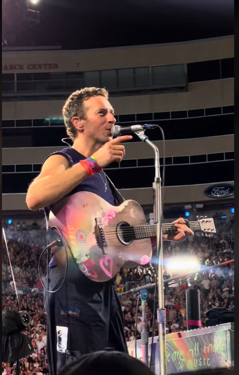 Coldplay's frontman, Chris Martin on stage during the concert, from a video post dated July 20, 2025 | Source: TikTok/jarev91