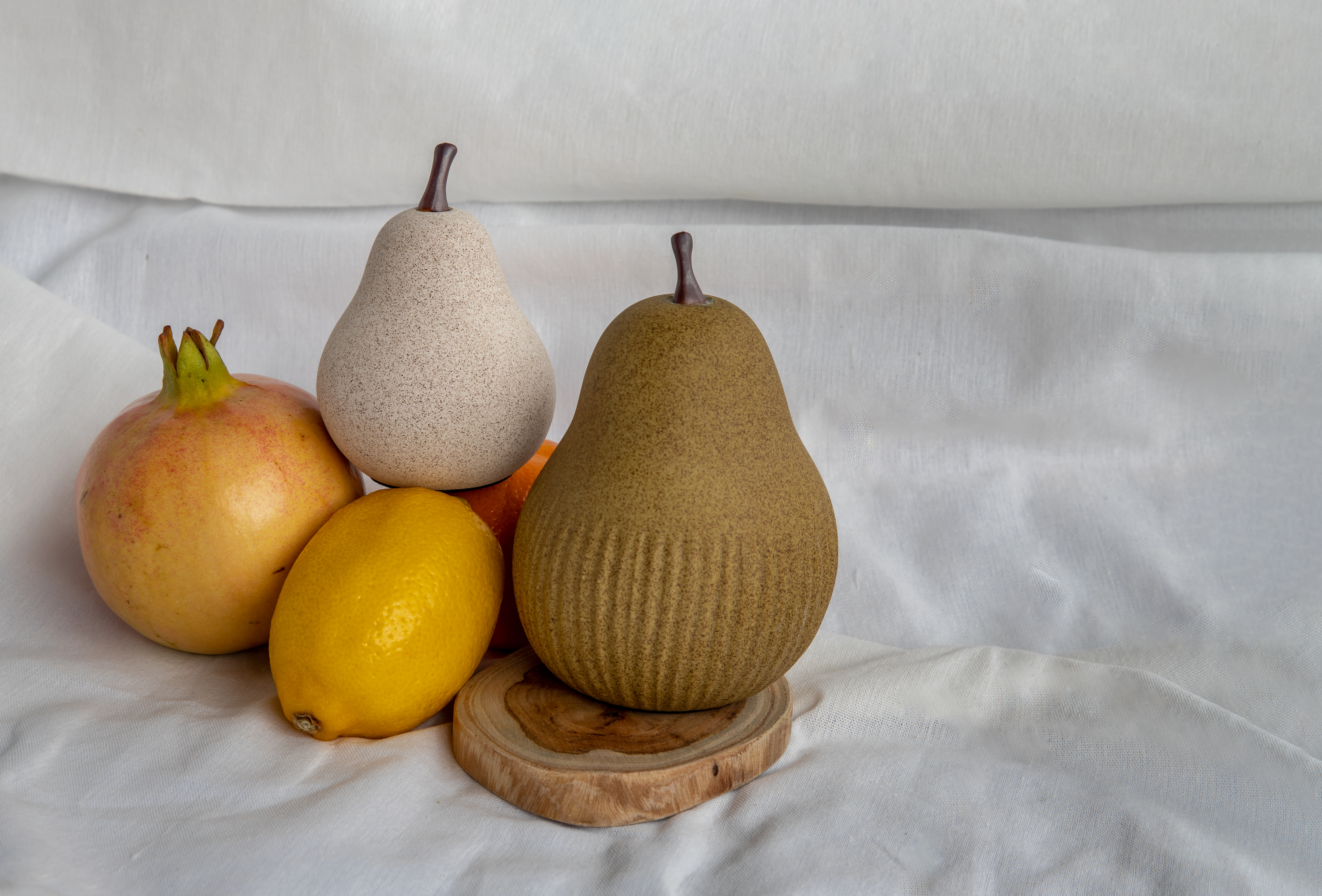 Ceramic pears with a lemon and pomegranate | Source: Shutterstock