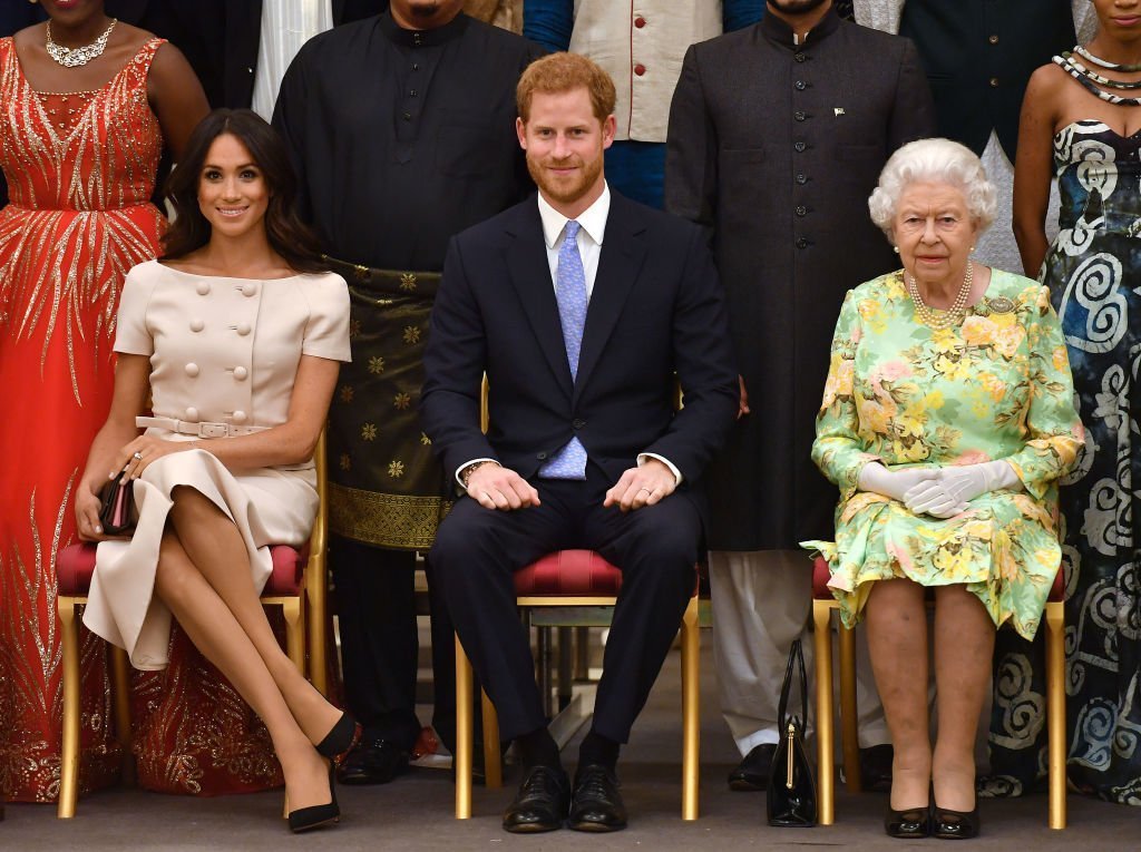 Meghan, Duchess of Sussex, Prince Harry, Duke of Sussex and Queen Elizabeth II at the Queen's Young Leaders Awards Ceremony at Buckingham Palace | Photo: Getty Images