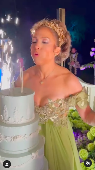 Jennifer Lopez blowing out her birthday candles during her 55th birthday celebration, posted on July 24, 2024 | Source: Instagram/jlo