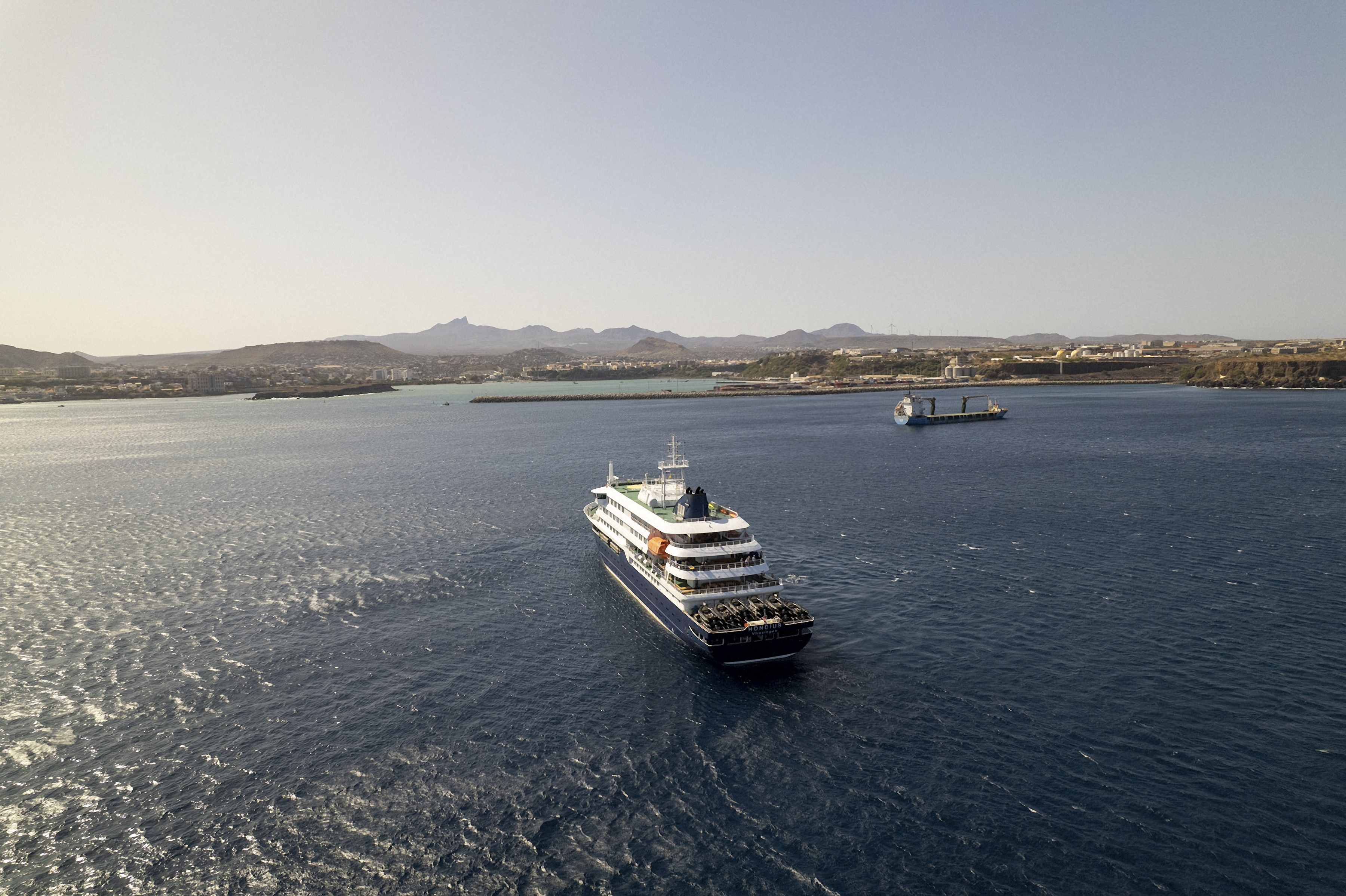 This aerial picture shows a general view of the cruise ship MV Hondius stationary off the port of Praia, the capital of Cape Verde, on 3 May 2026. | Source: Getty Images