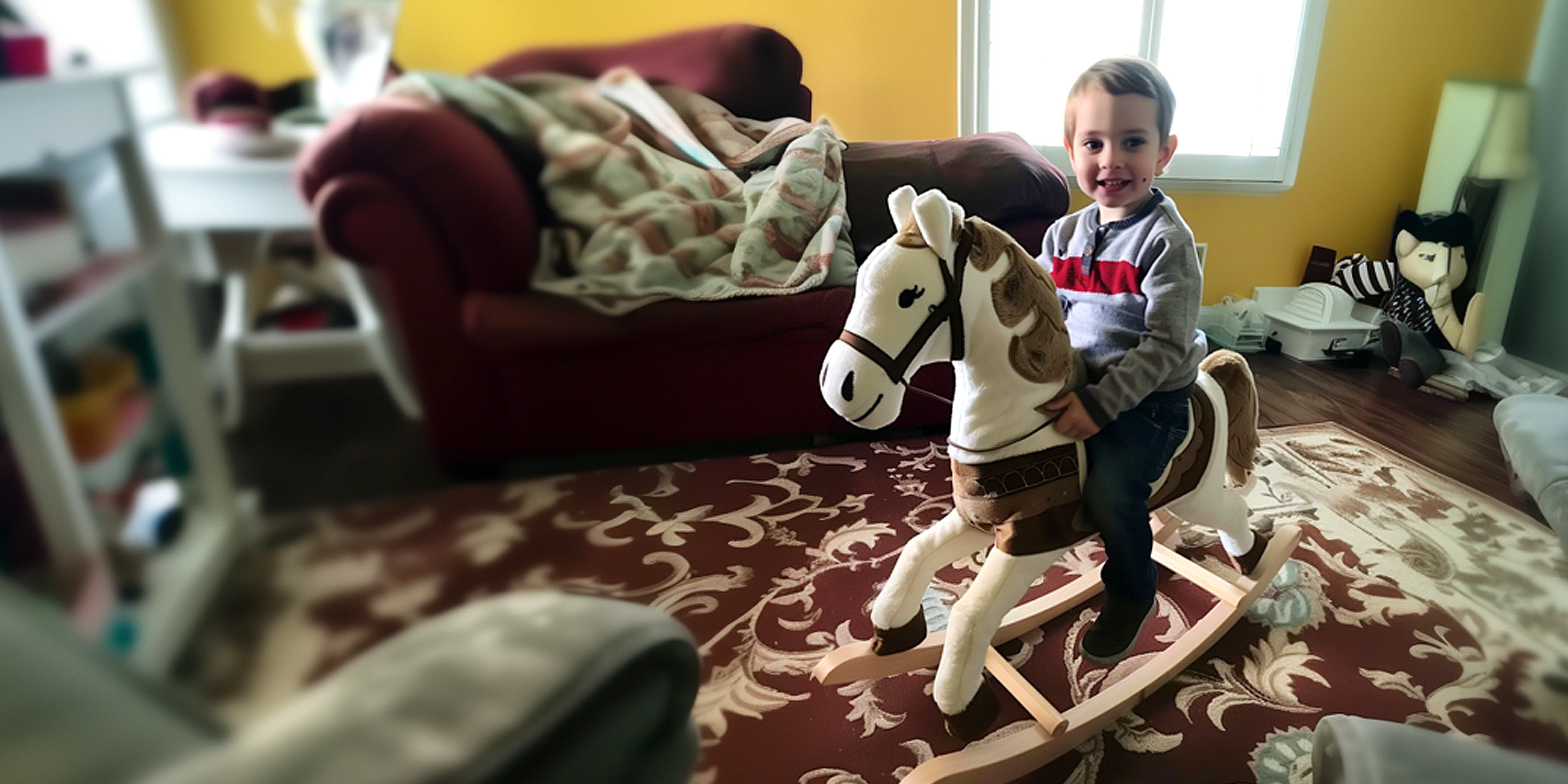 A boy on a rocking horse | Source: Amomama