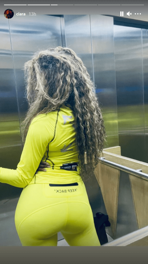 Singer Ciara dressed in a yellow tracksuit and posing in an elevator | Photo: Instagram/ciara