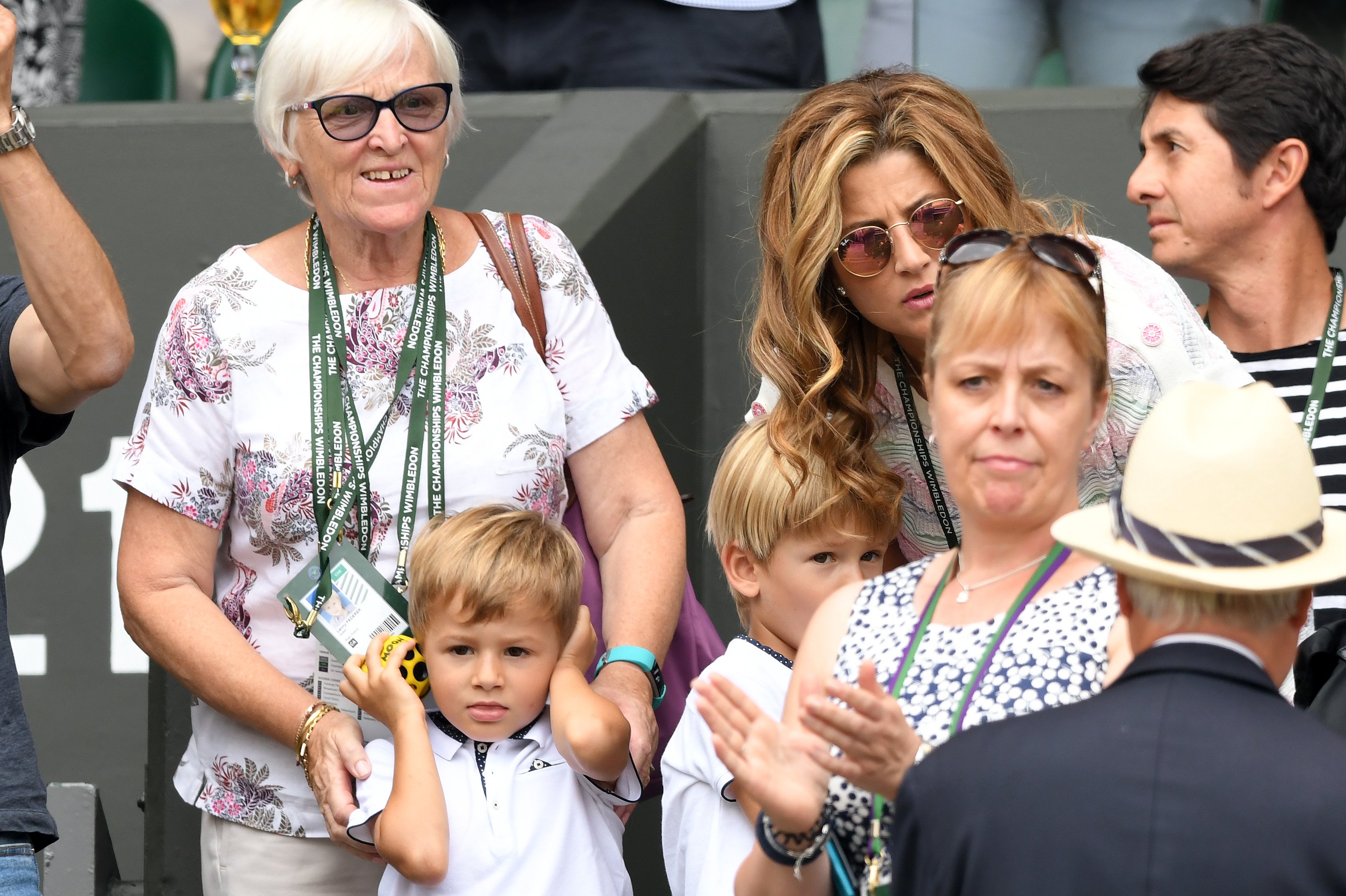 Lennert "Lenny" Federer covers his ears beside his brother Leo Federer at the All England Lawn Tennis and Croquet Club on July 9, 2018, in London, England. | Source: Getty Images