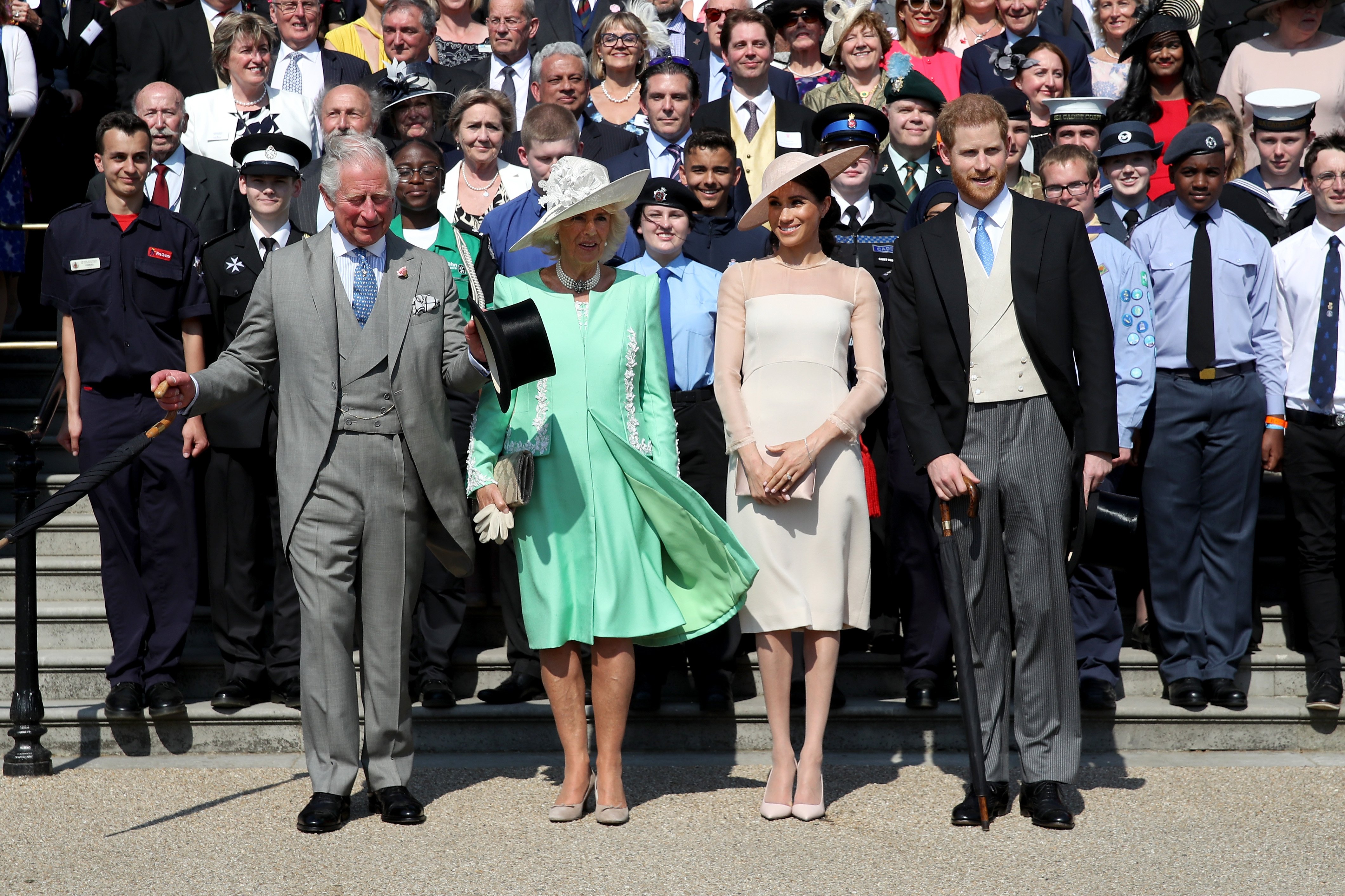 Prince Harry, Duke of Sussex, Prince Charles, Prince of Wales, Camilla, Duchess of Cornwall, Meghan, Duchess of Sussex and guests pose for a photograph as they attend The Prince of Wales' 70th Birthday Patronage Celebration held at Buckingham Palace on May 22, 2018 in London, England | Source: Getty Images 