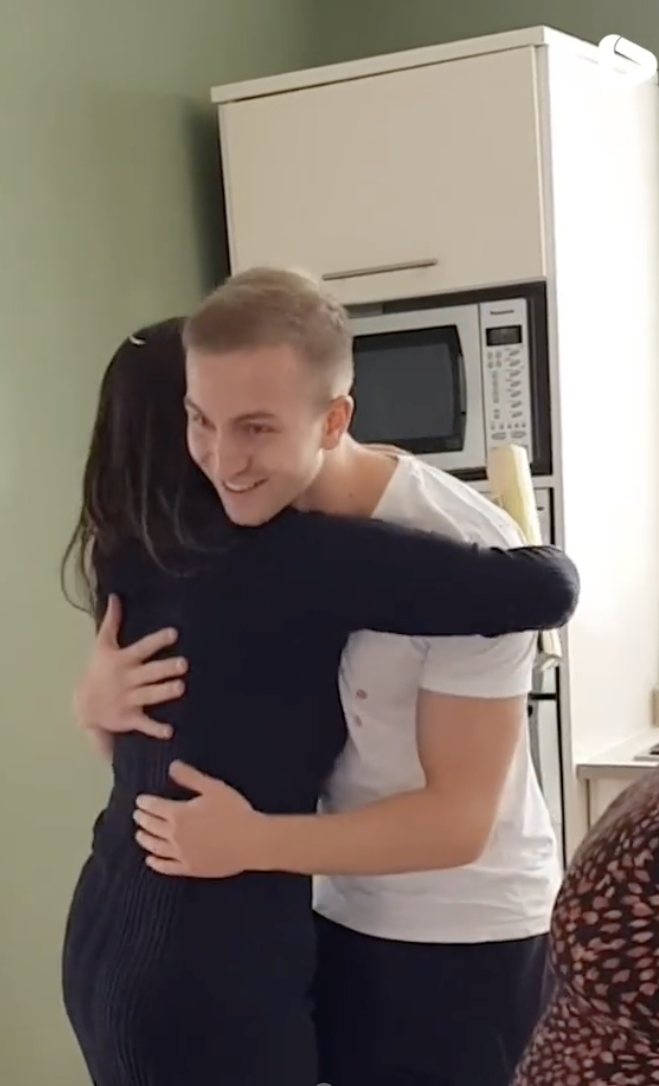 A man and his wife hugging at their child's gender reveal party | Source: tiktok.com/@itsgoneviral