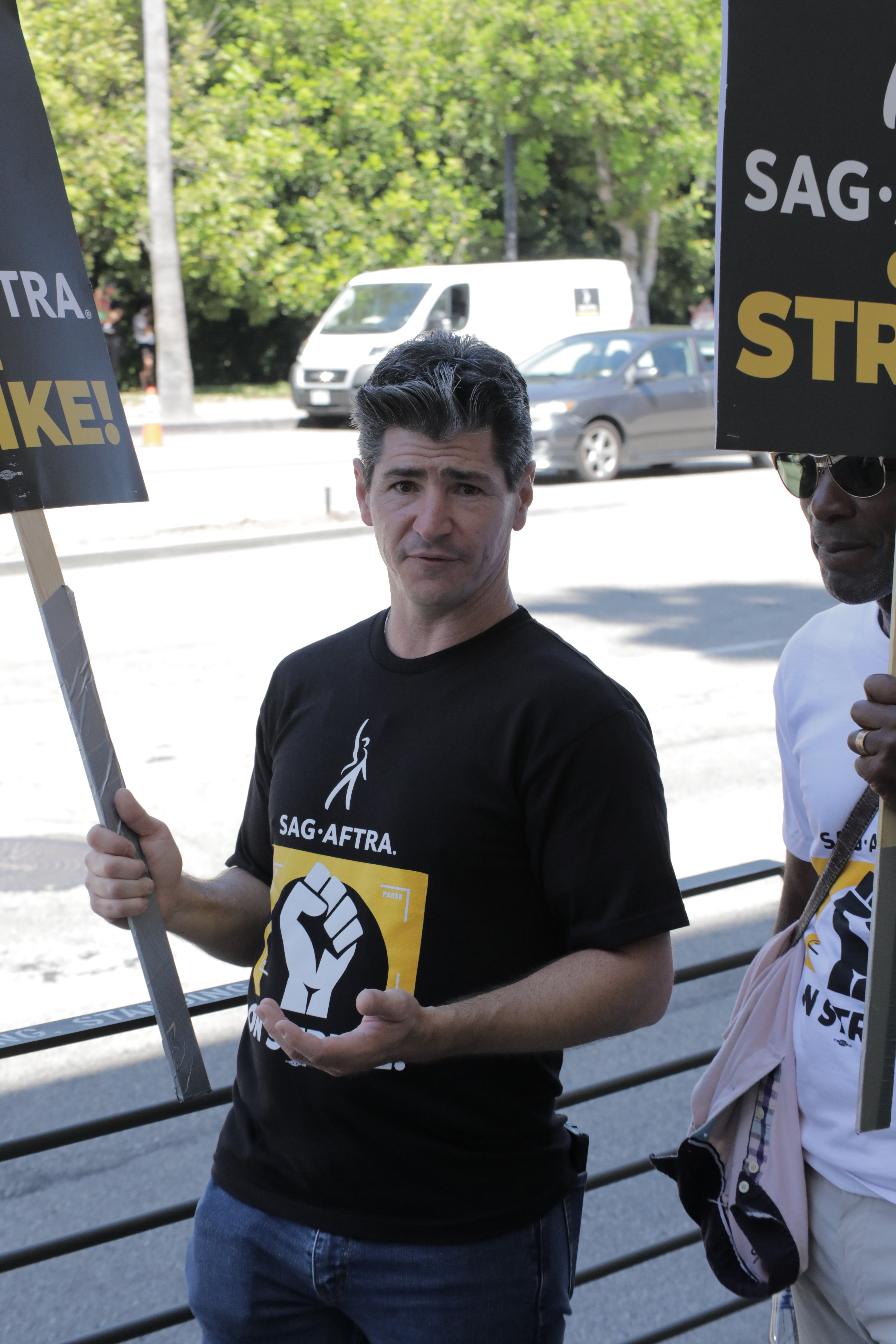 Michael Fishman stood in solidarity with his fellow actors and writers during industry labor actions. In this photo, he walked the picket line outside Warner Bros. Studios in support of the SAG-AFTRA and WGA strike on August 3, 2023, in Burbank, California. | Source: Getty Images Getty Images