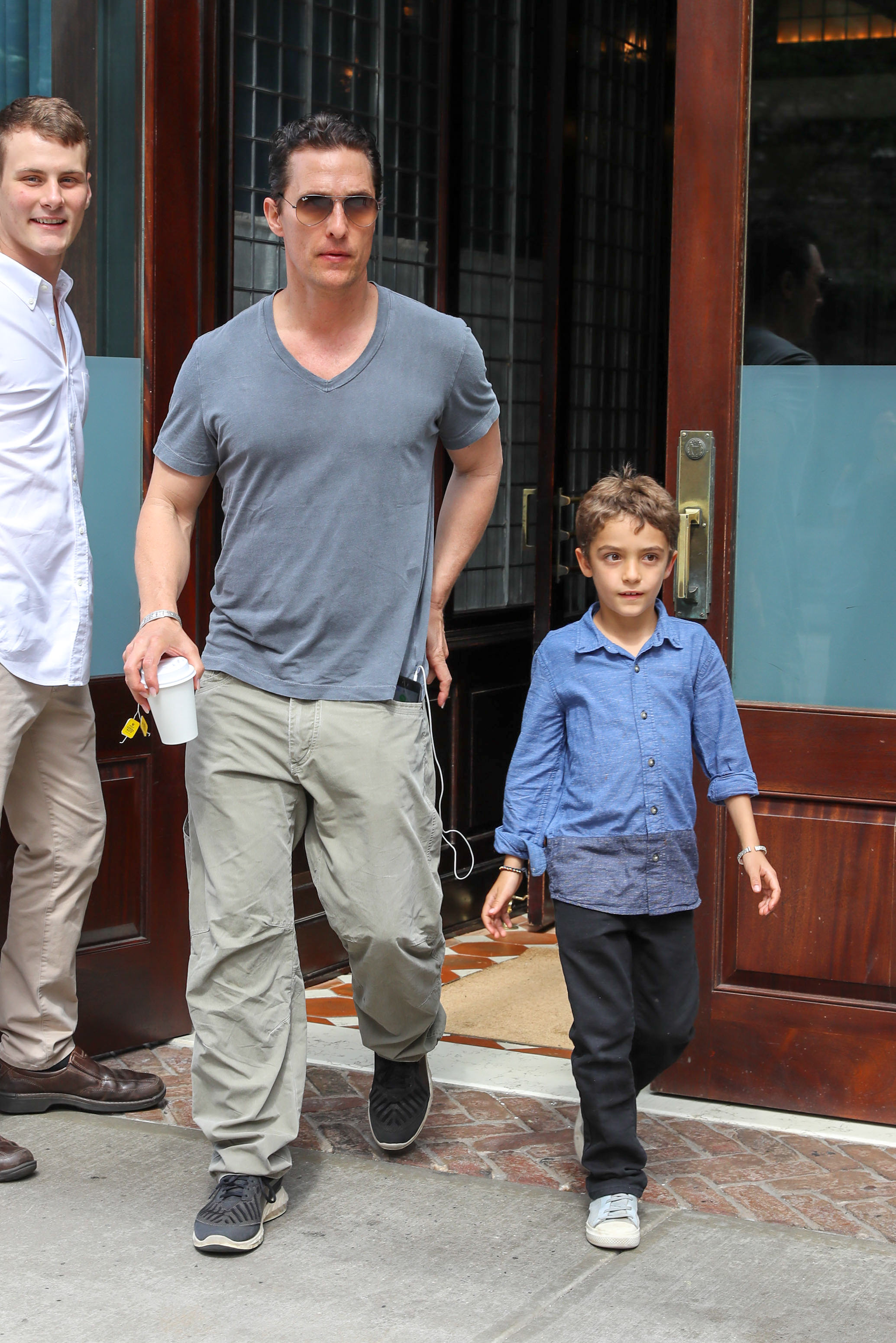 Budding teen cool — On June 27, 2016, Levi steps out in NYC in a blue button-down and sneakers, walking beside dad Matthew.